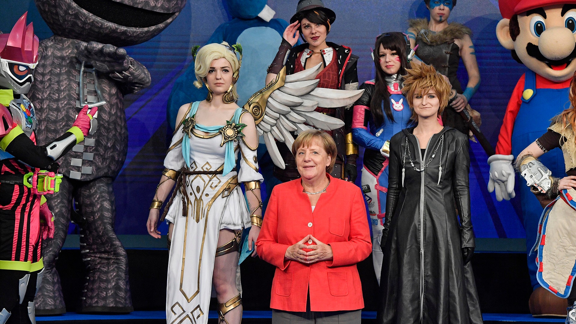 German chancellor Angela Merkel poses with cosplayers at the Gamescom fair for computer games