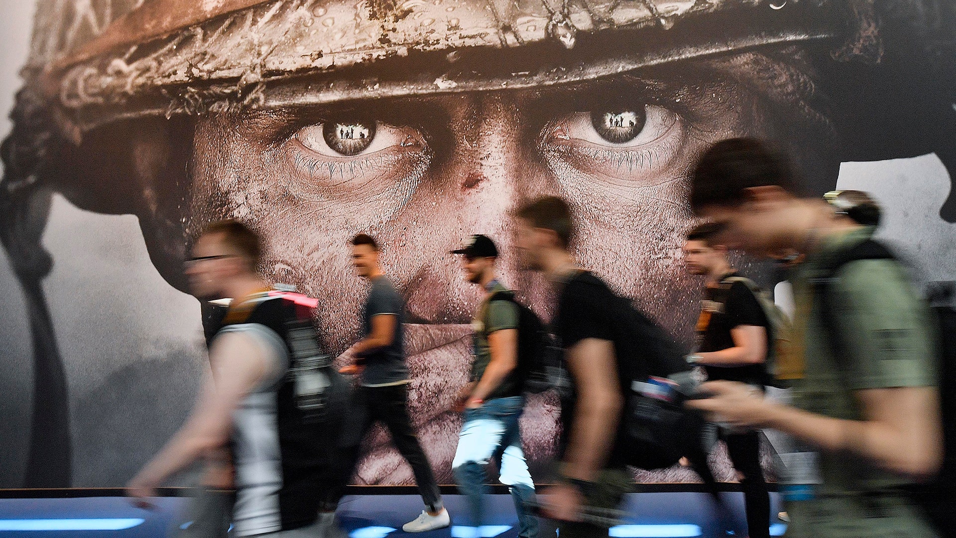 Visitors passing an advertisement for the video game 'Call of Duty' at Gamescom