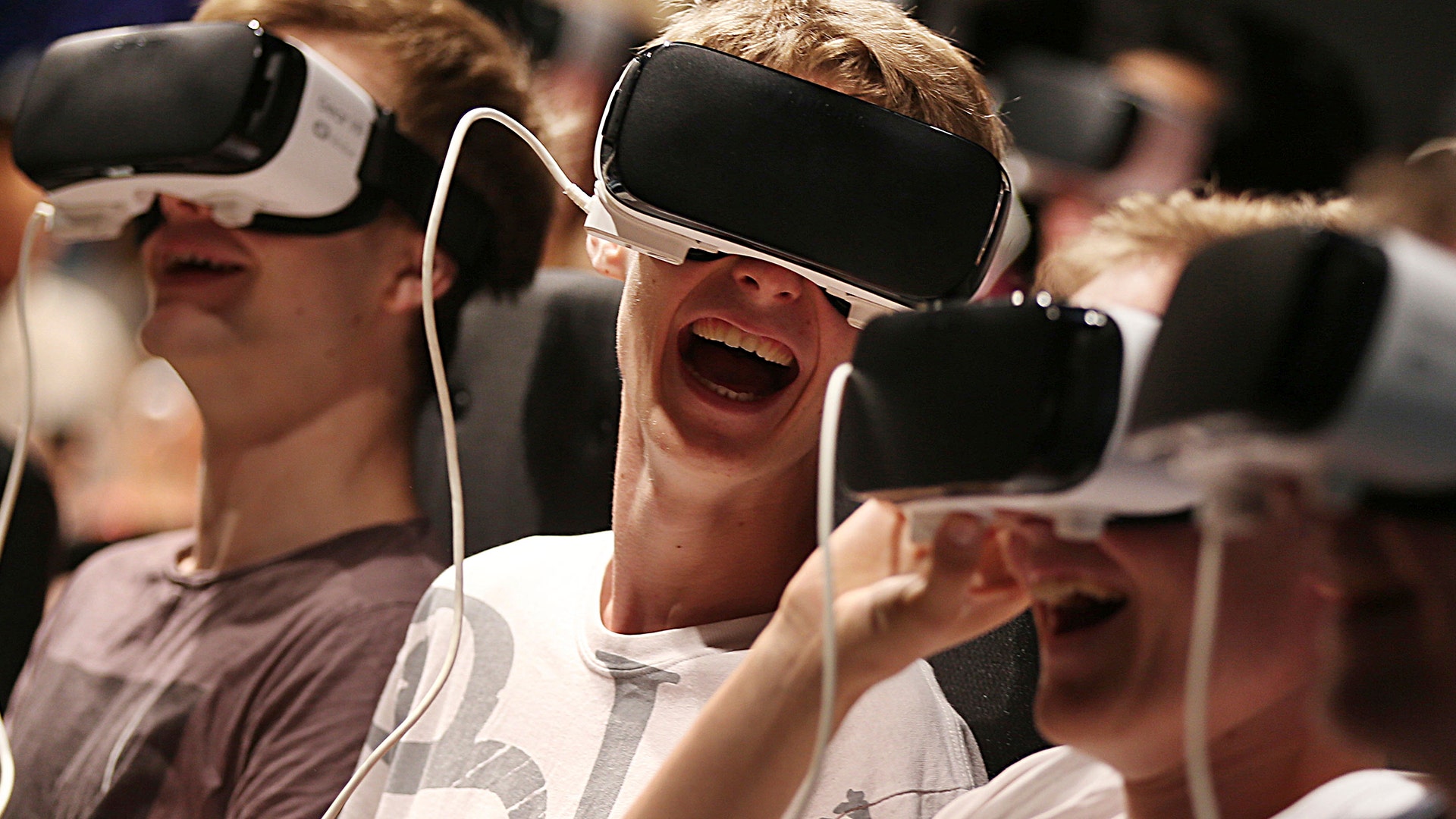 Attendees with virtual reality headsets have fun at the Gamescom fair Aug. 23, 2017