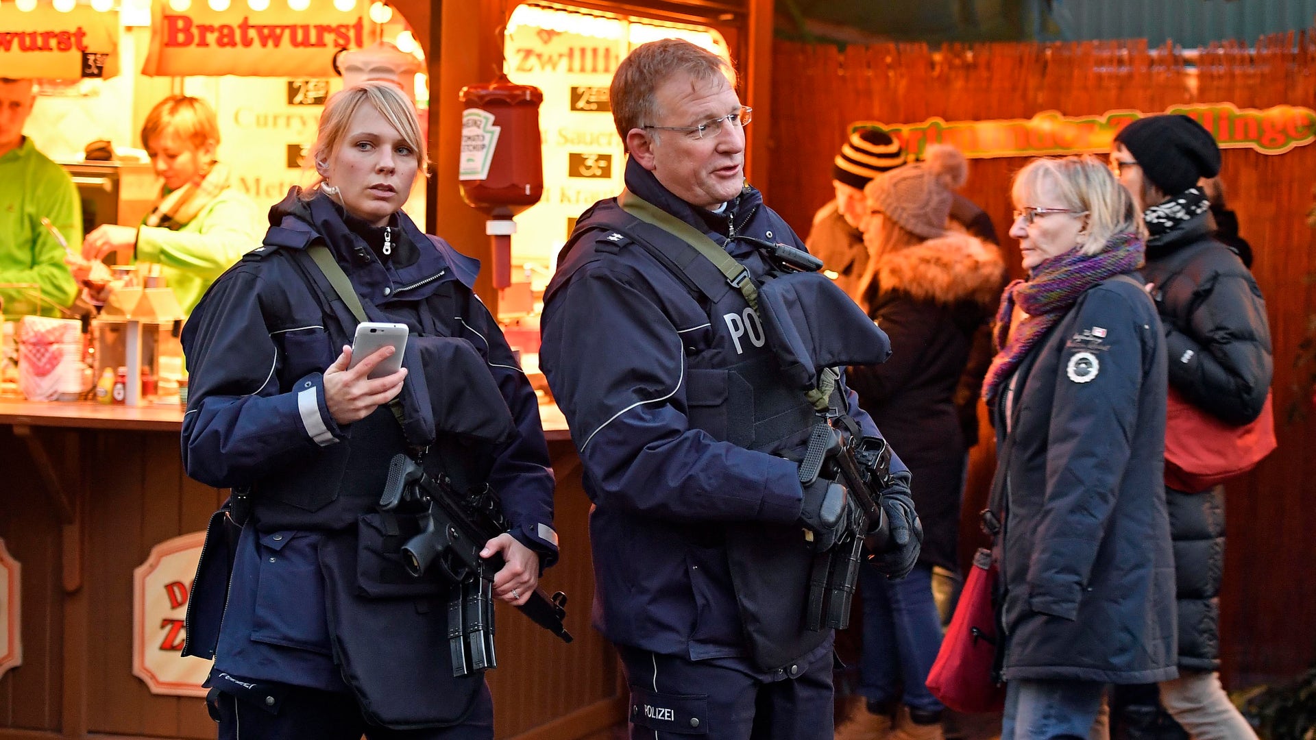 Police officers patrol at the Christmas market in Dortmund, Germany, Tuesday Dec. 20, 2016. A truck ran into a crowded Christmas market in Berlin the evening before and killed several people.