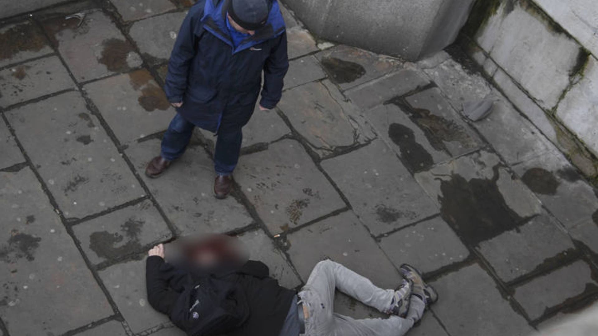 A man lies injured on Westminster Bridge.