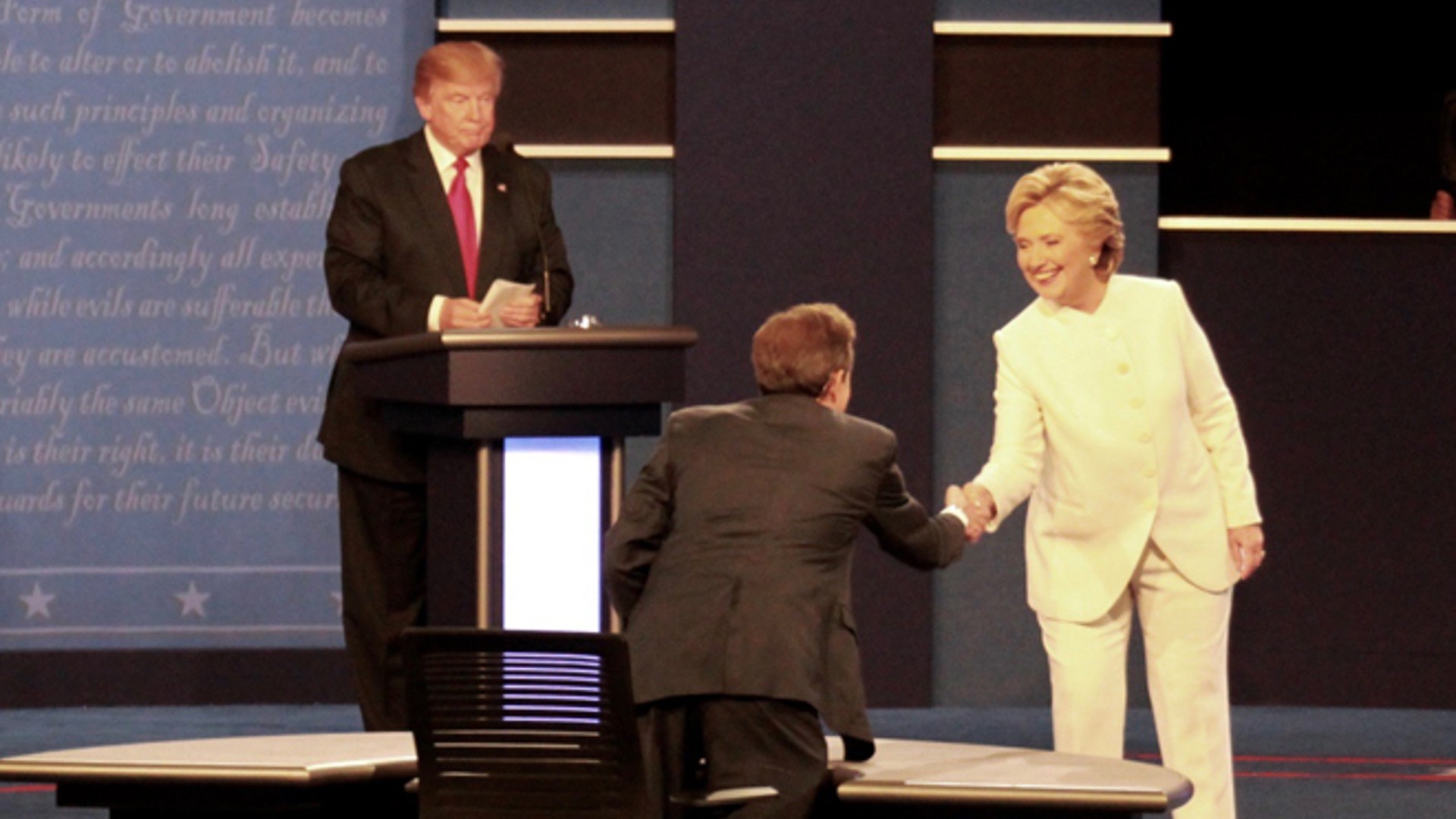 Democratic presidential nominee Hillary Clinton shakes hands with moderator Chris Wallace at the final debate