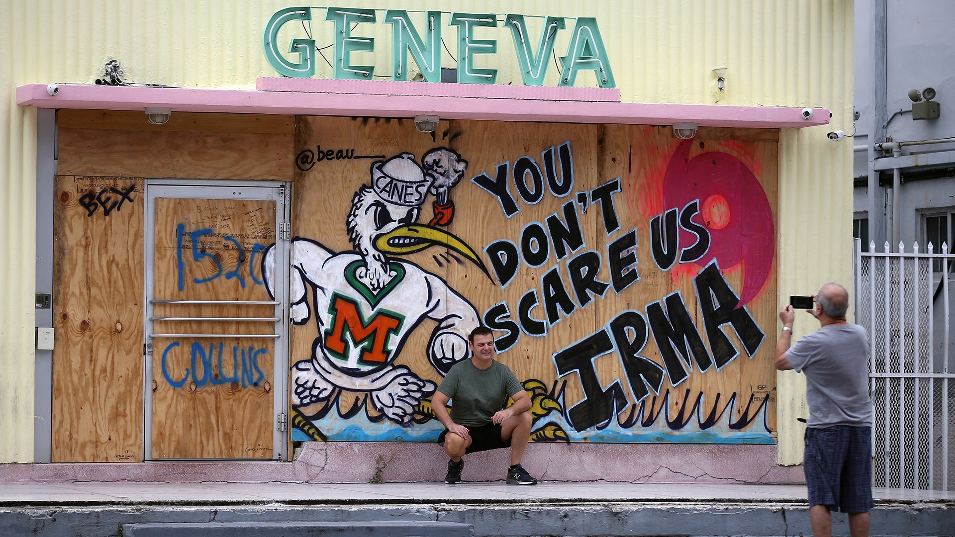 A tourist poses for a picture outside of a shop in South Beach