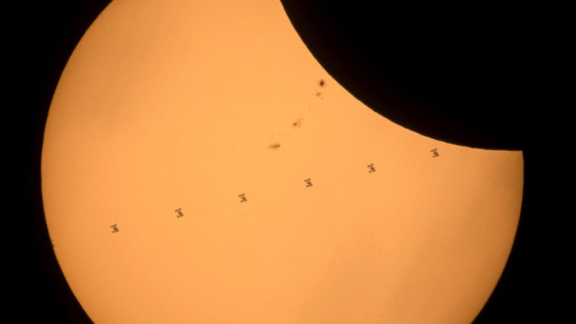 The International Space Station as it transits the Sun at roughly five miles per second during partial solar eclipse, near Banner, Wyoming
