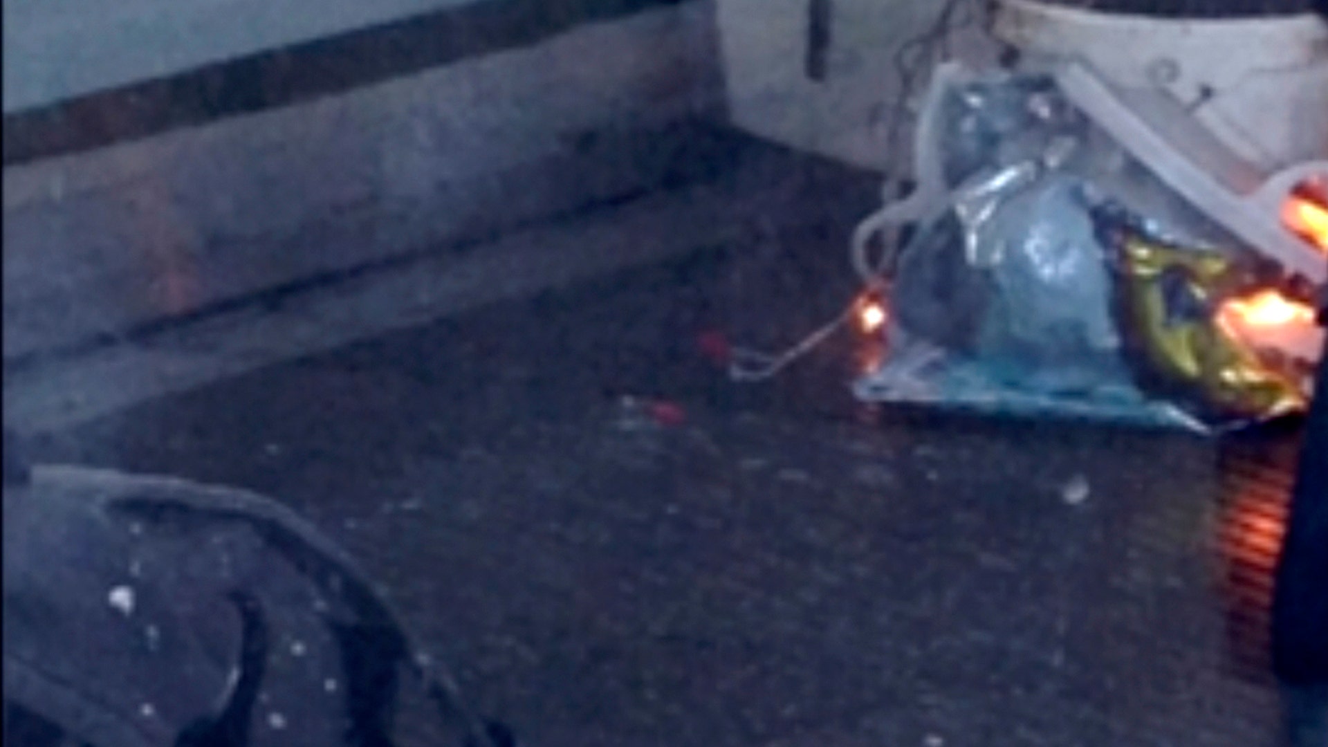 A fire on a plastic bucket burns at southwest London subway station after an explosion.