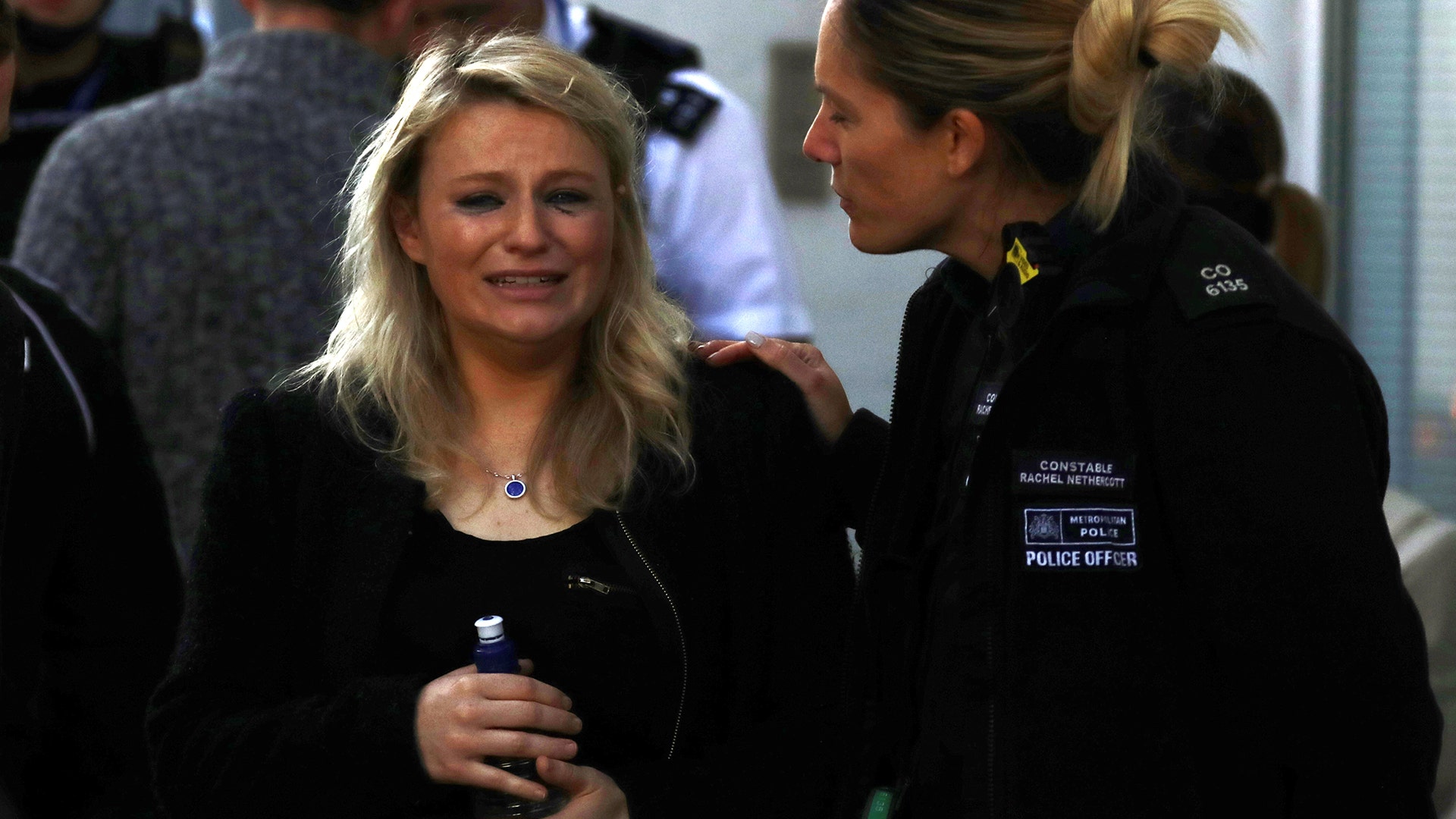 A woman reacts outside Parsons Green subway station in London.