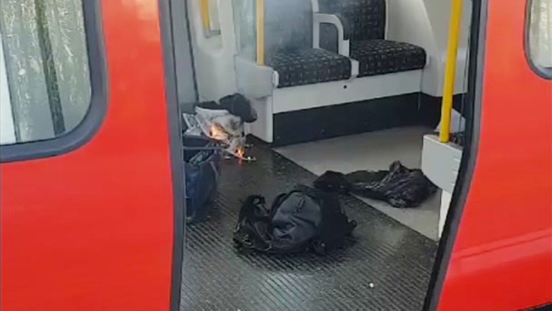 This is an image made from video showing burning items in underground train at the scene of an explosion in London Friday