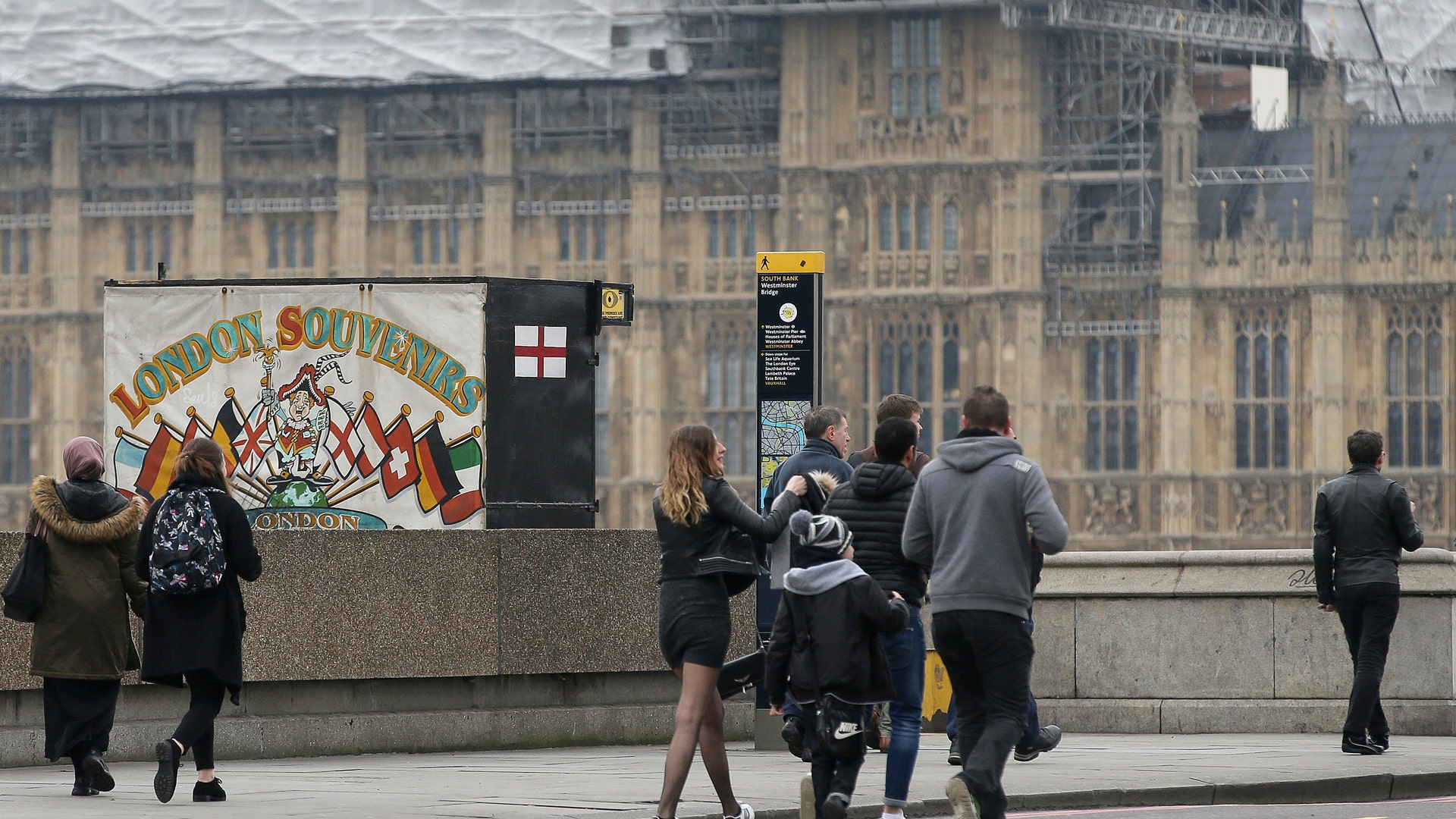 People walk over Westminster Bridge after it was re-opened to the public Thursday, March 23, 2017.