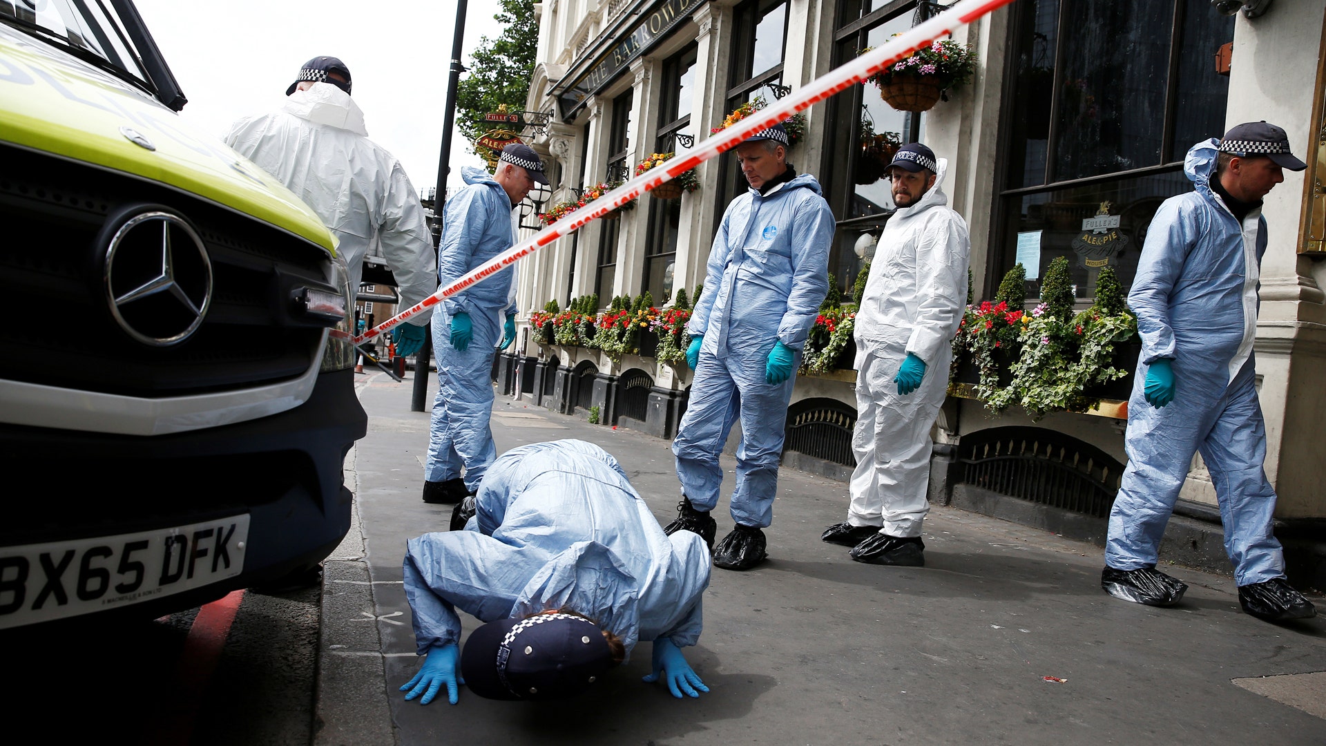 Forensics investigators work at the south end of London Bridge, near Borough Market 