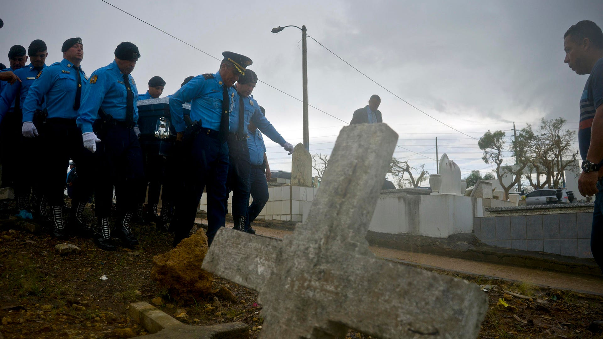 Police officers carry the coffin of their colleague Luis Angel Gonzalez Lorenzo, killed during the passage of Hurricane Maria
