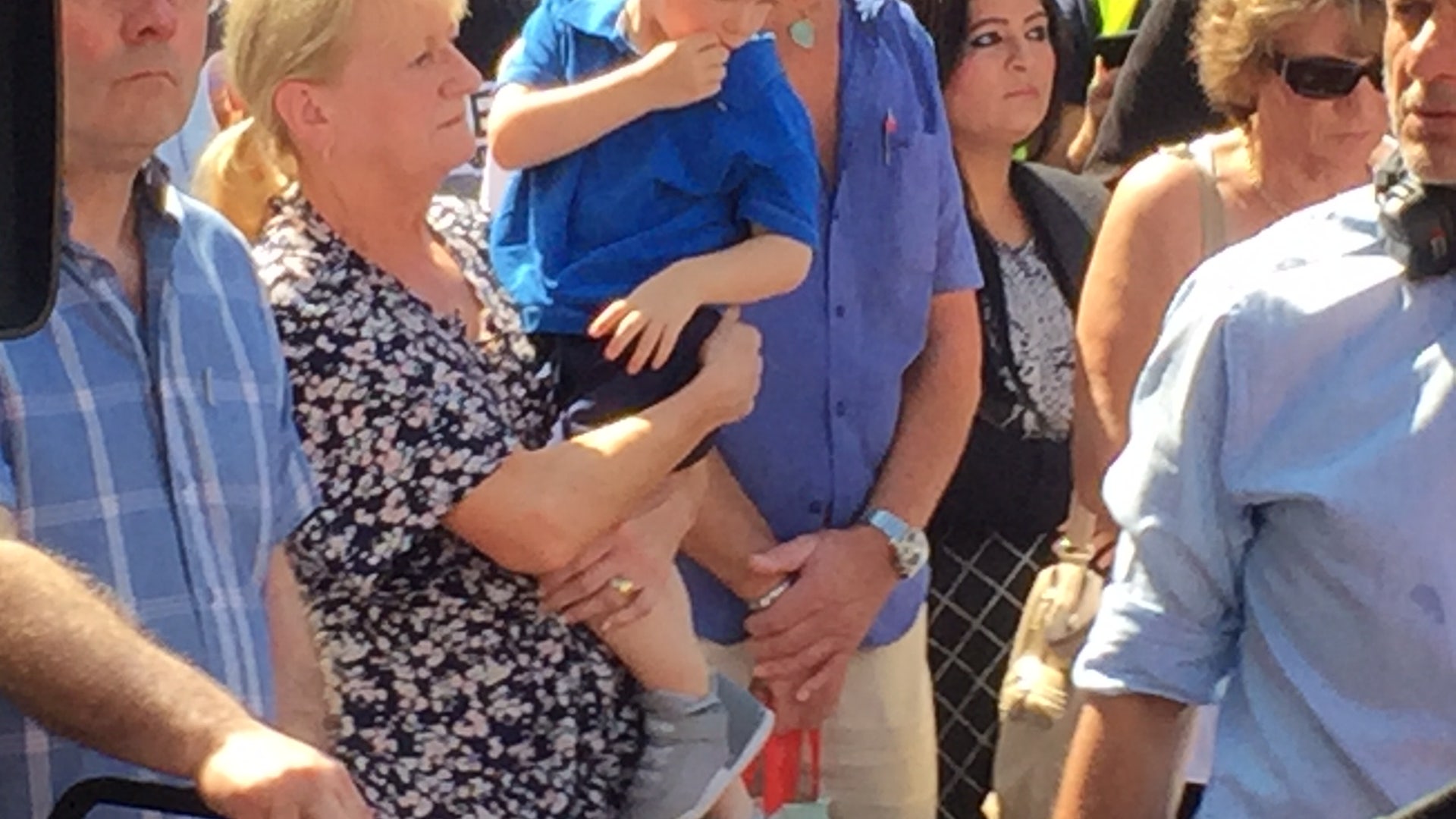 People look at tributes in Manchester, England days after the terror attack at the Ariana Grande concert.