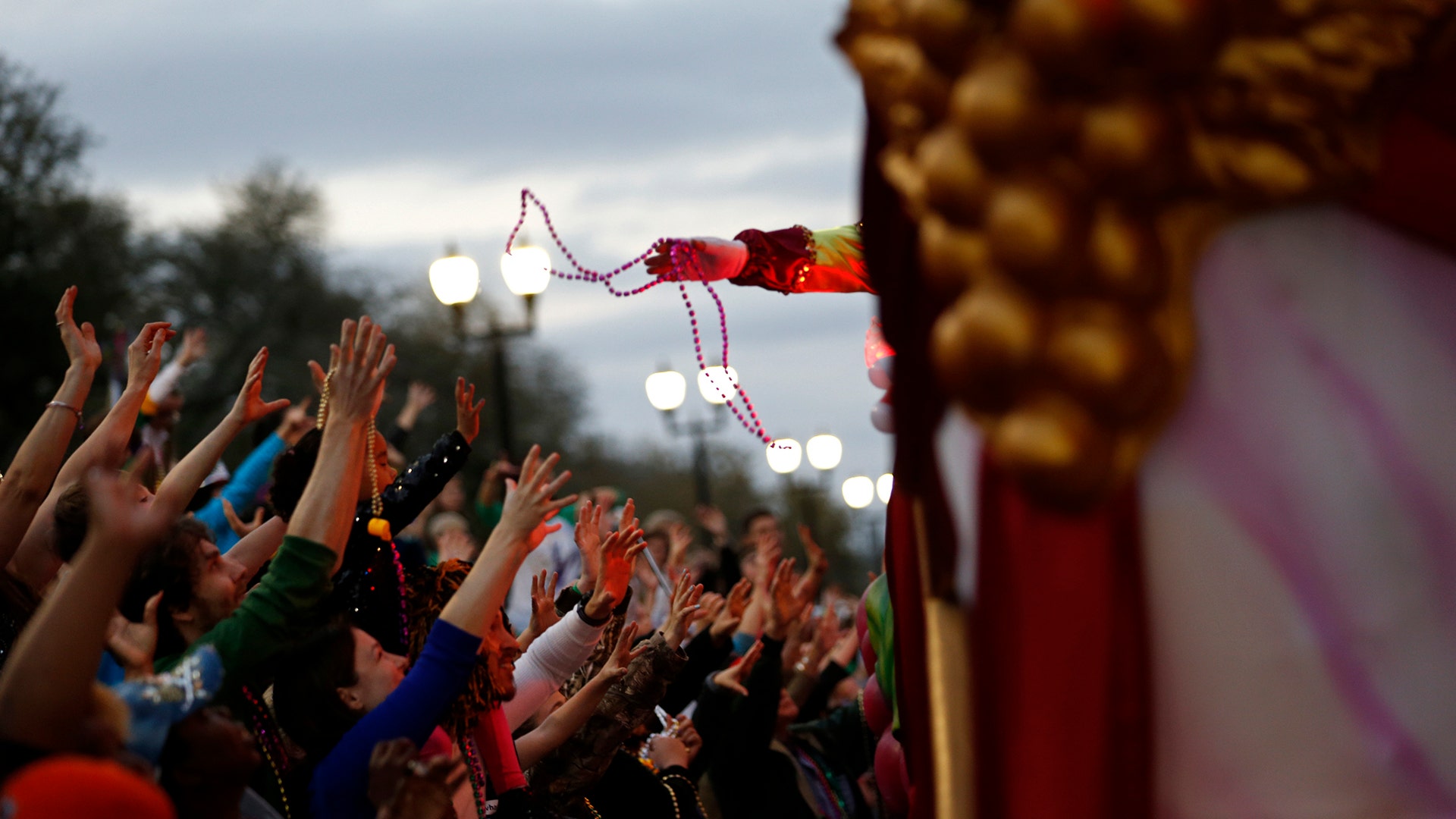 A float rider tosses beads during the Krewe of Bacchus Mardi Gras parade in New Orleans.