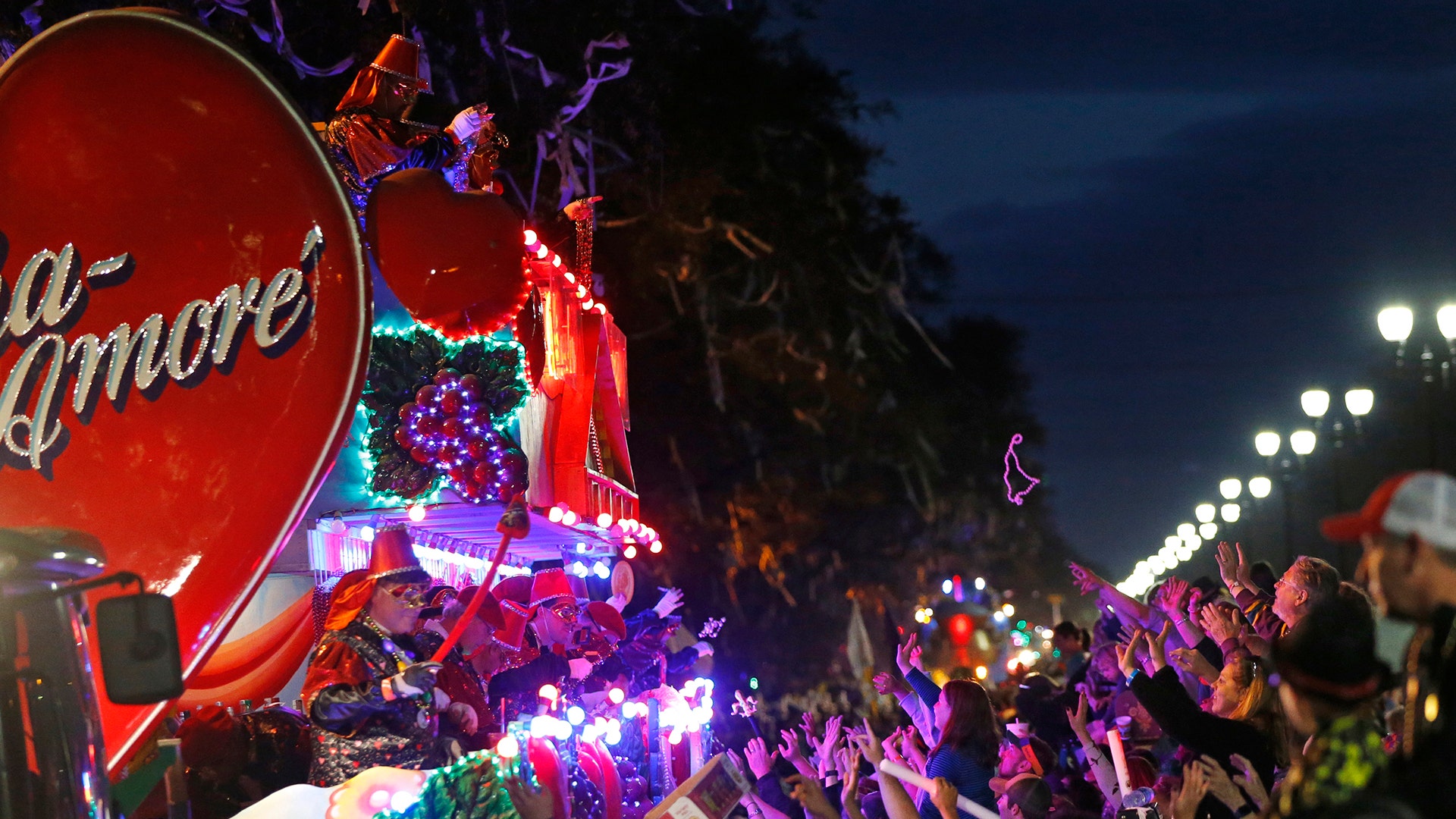 Float riders toss beads during the Krewe of Bacchus Mardi Gras parade in New Orleans.