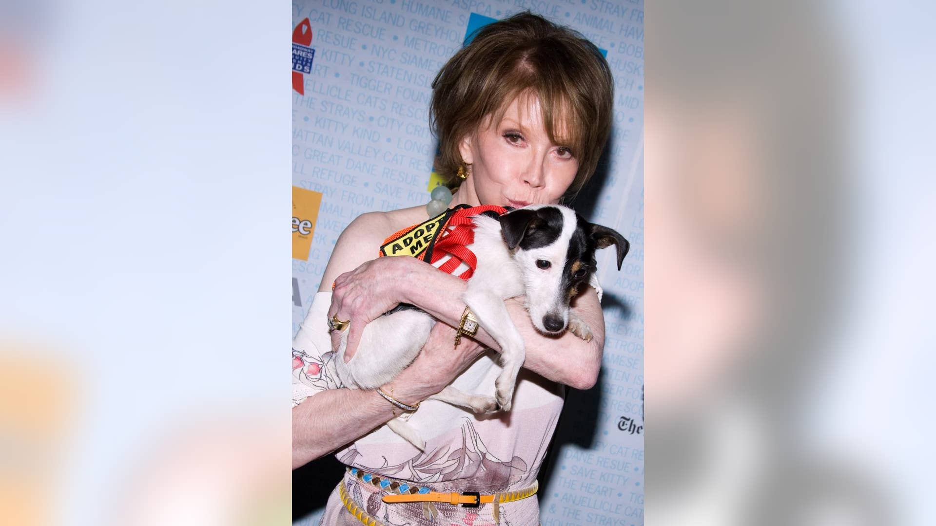 Mary Tyler Moore poses with a dog up for adoption at Broadway Barks