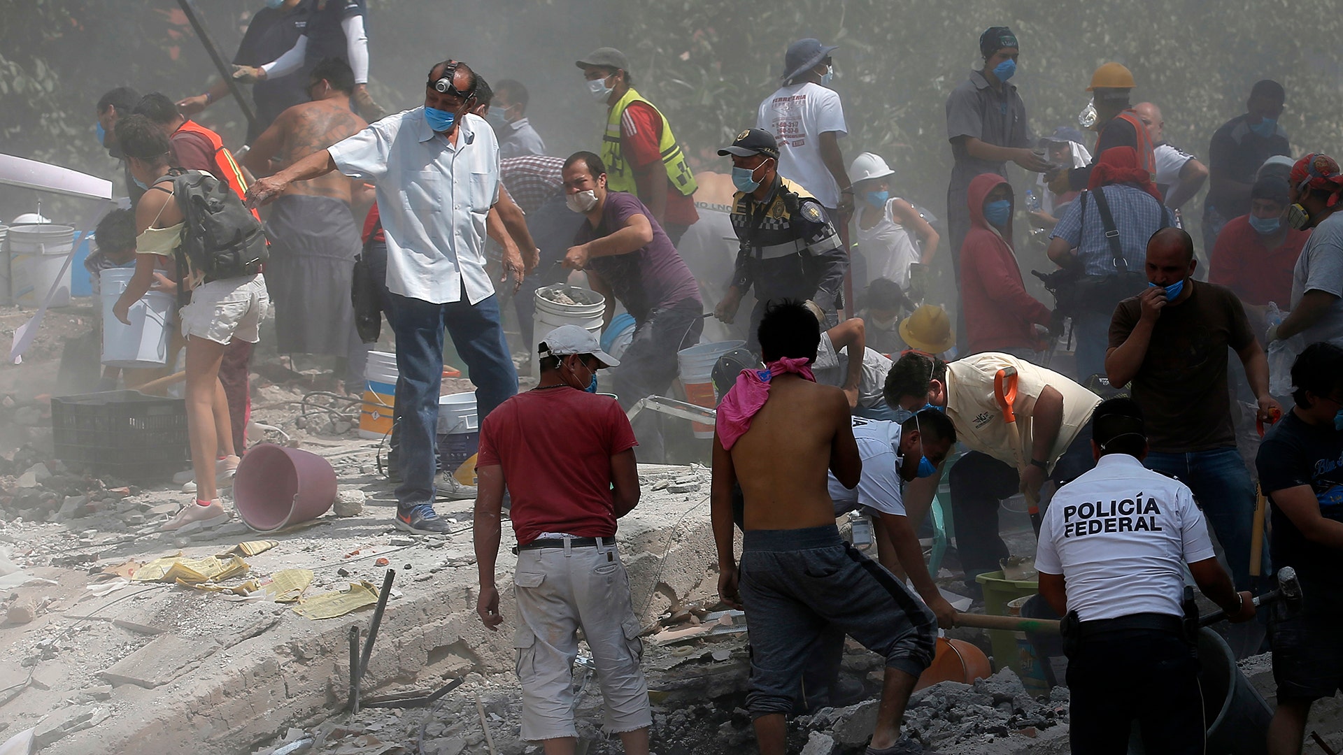 Volunteers search a building that collapsed after an earthquake, in the Roma neighborhood of Mexico City