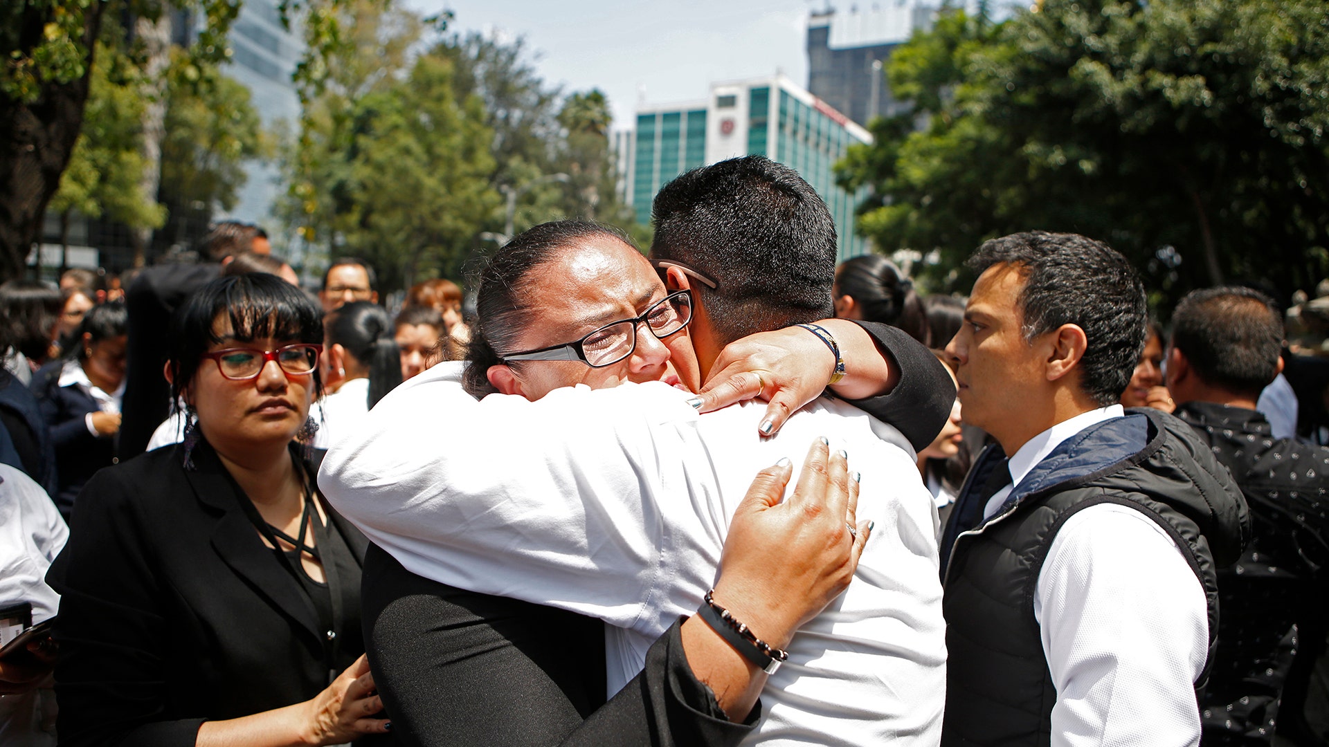 A woman is comforted after an earthquake in Mexico City 