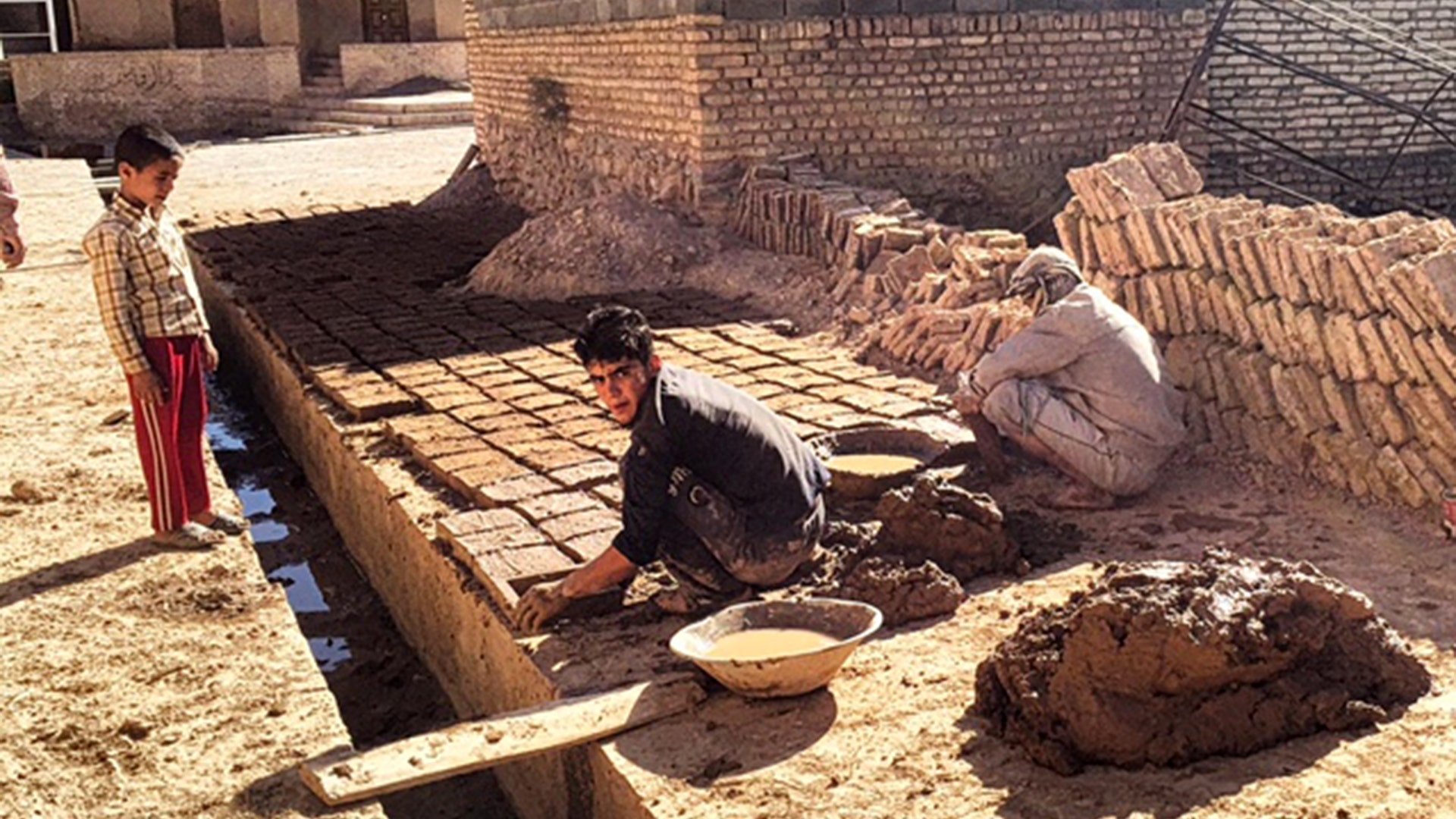 Young boys working to restore ancient villages in Yazd province
