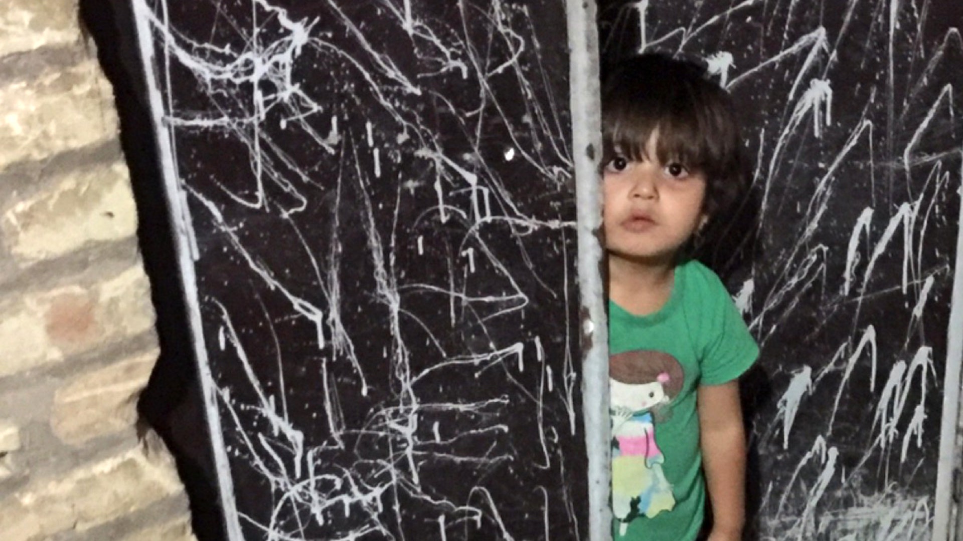 Small child peeking from her home in Yazd