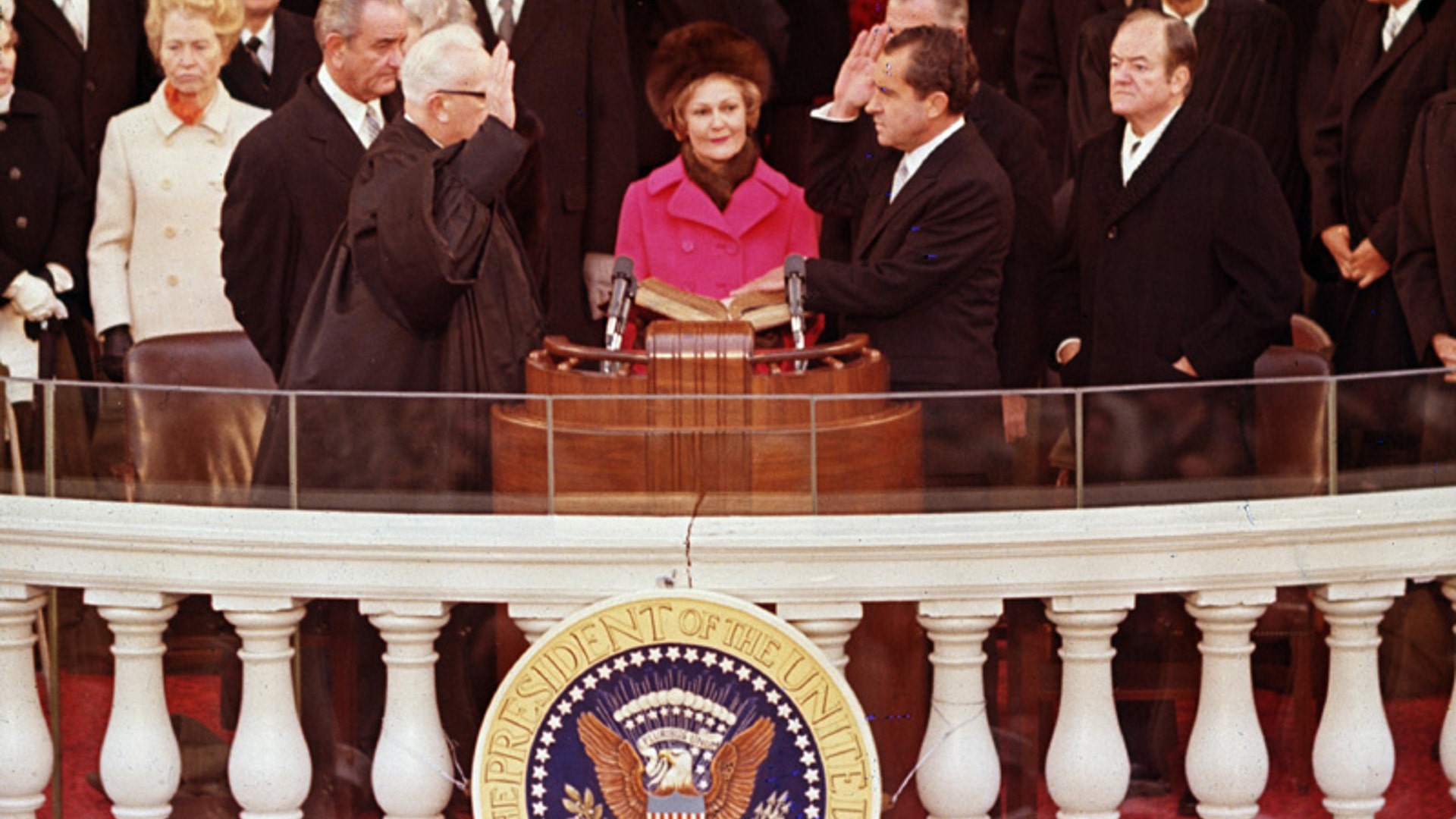 Pat Nixon holds the Bible for her husband, Richard Nixon, as he takes the oath of office, Jan. 20, 1969. 