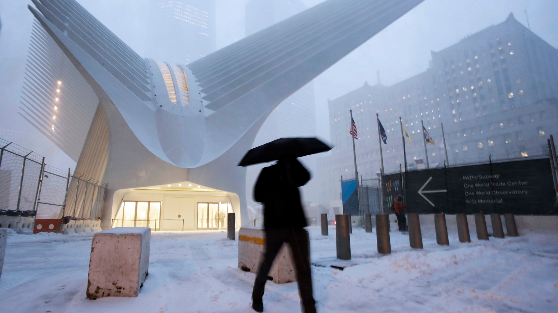A man makes his way through wind and snow past the Oculus of the World Trade Center Transportation Hub, Thursday, Feb. 9, 2017, in New York.