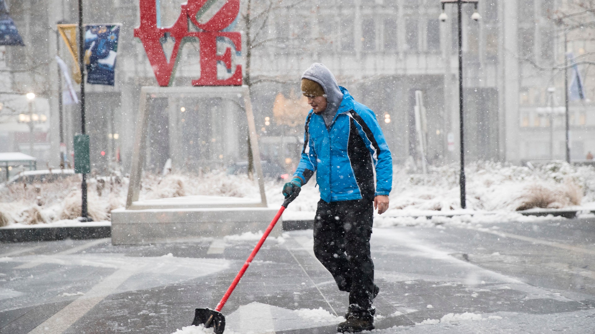 A man clears snow from Dilworth Park during a winter storm in Philadelphia, Thursday, Feb. 9, 2017. 