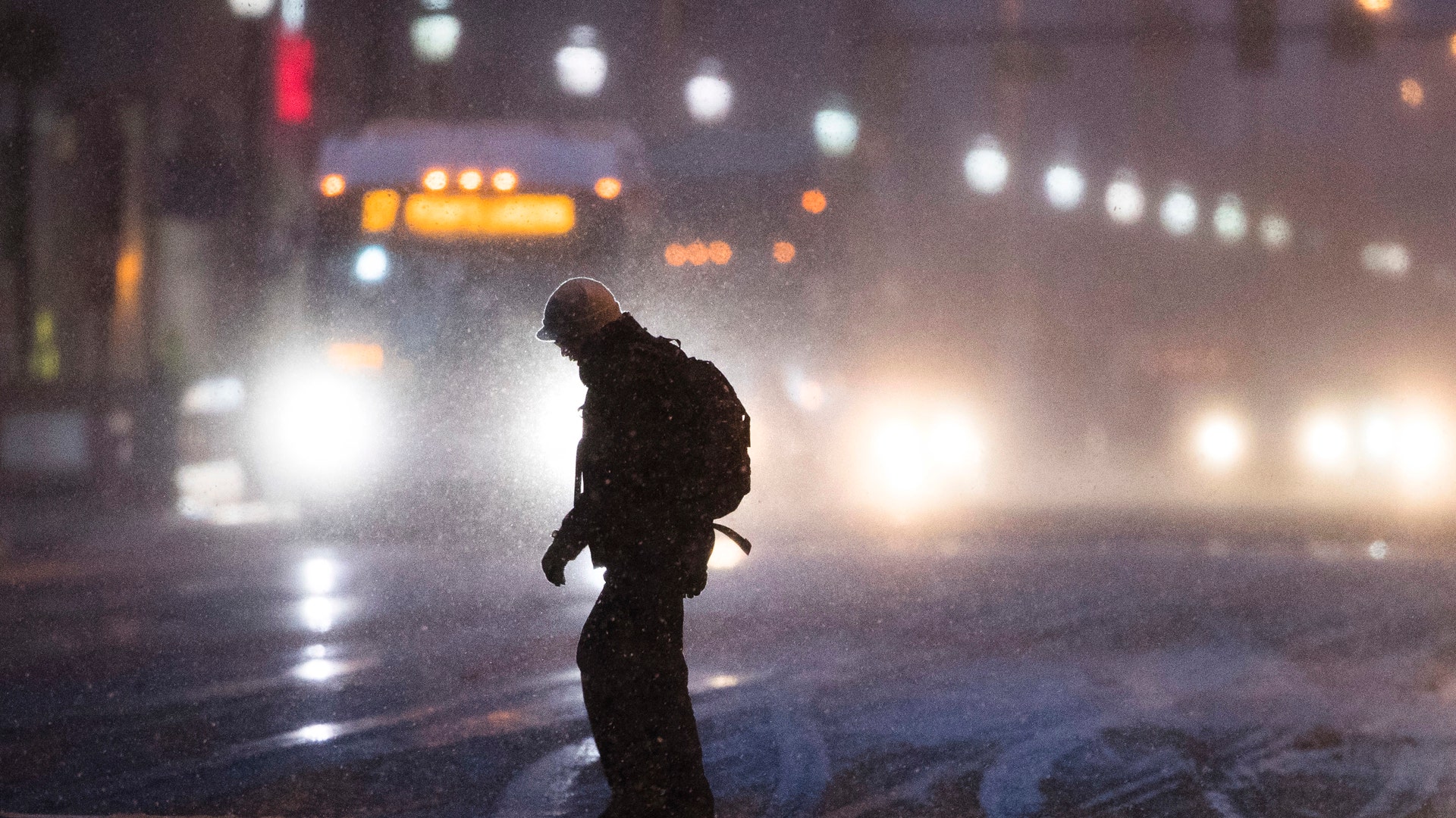 A man crosses Market Street during a winter storm in Philadelphia, Thursday, Feb. 9, 2017. 