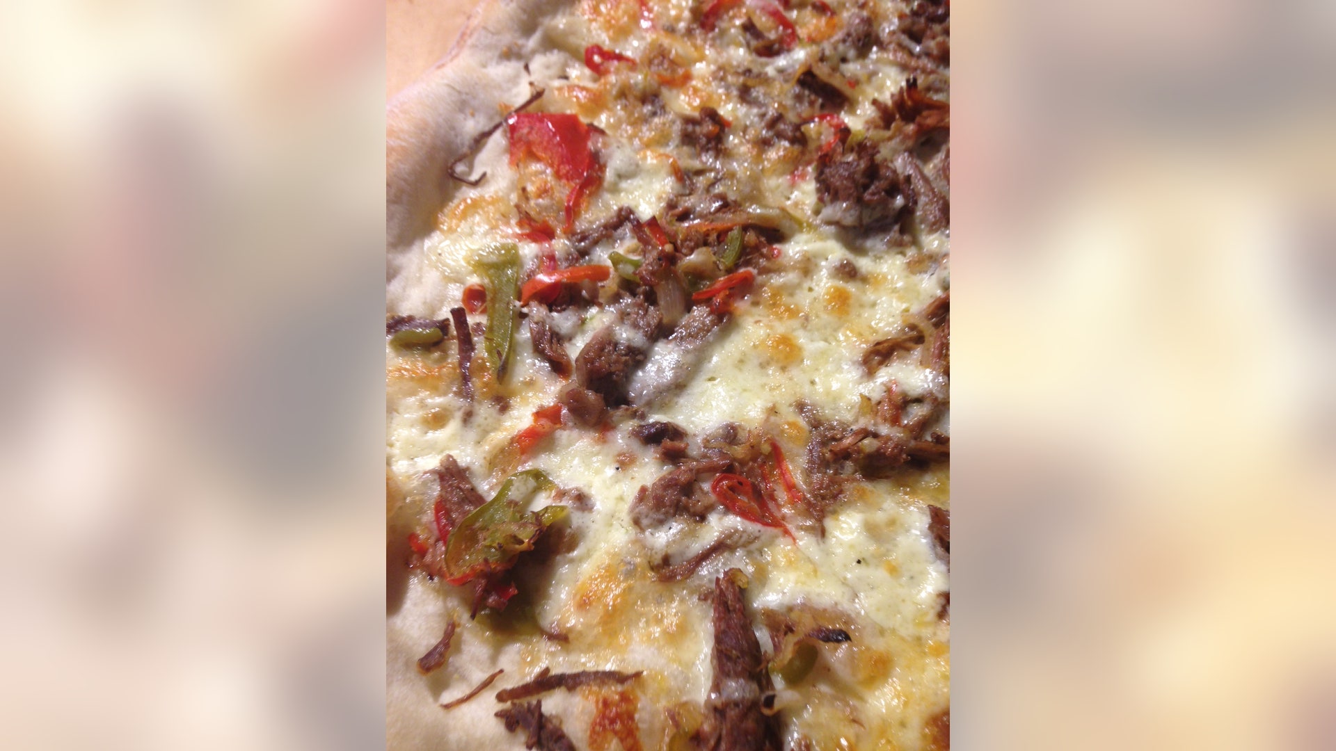 This Philly Cheese Steak inspired pizza might even be better than the real thing.