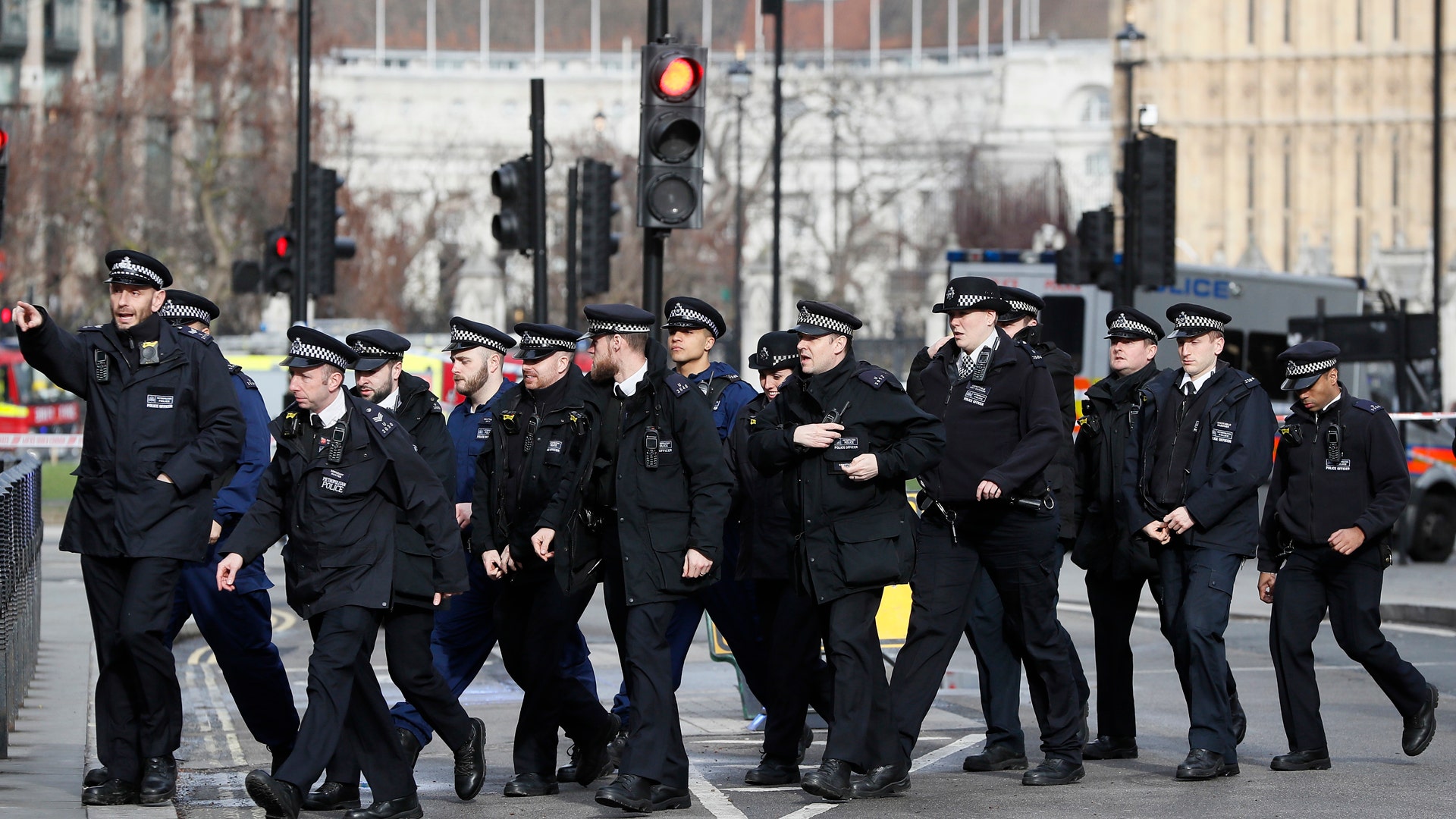 Police officers walk through Parliament in London, Wednesday, March 22, 2017.