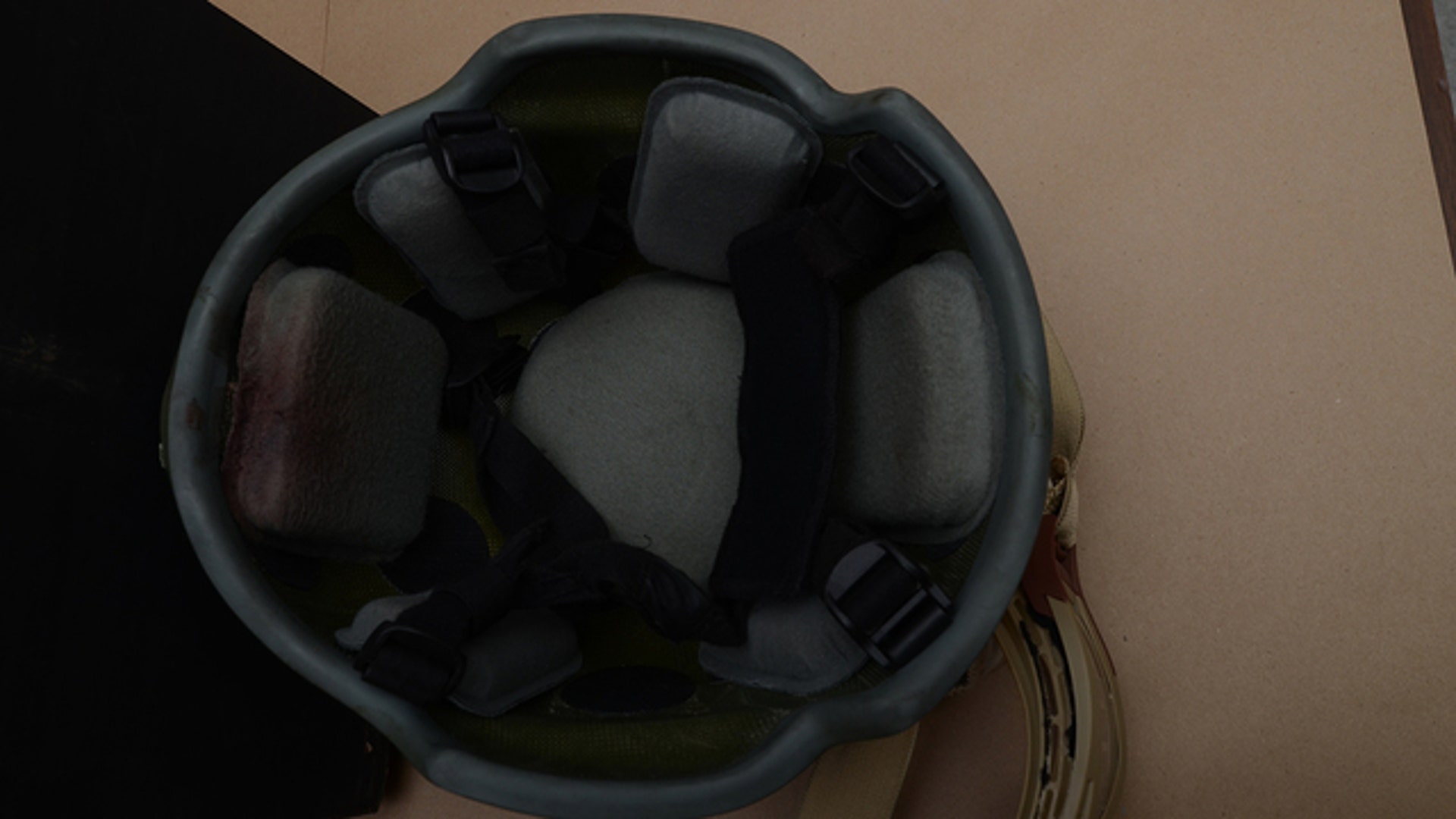 A police officer's helmet damaged by a bullet.