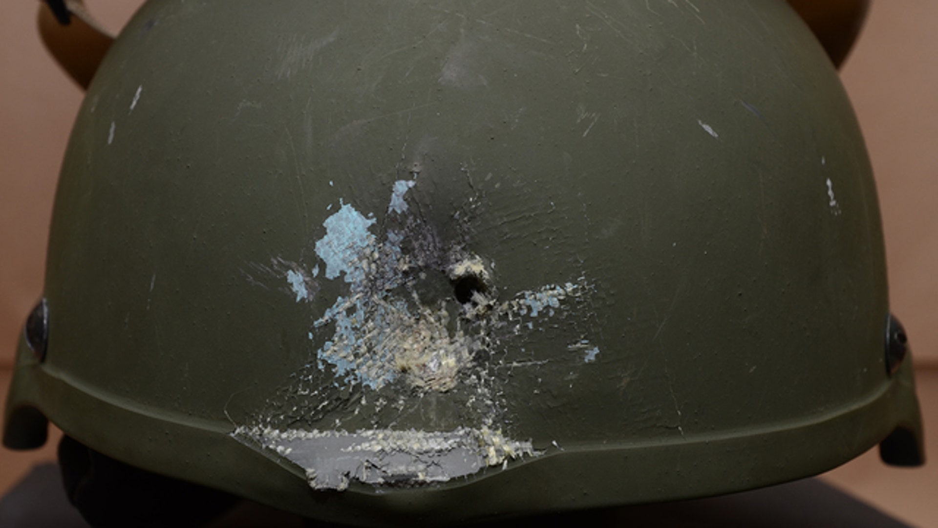 A police officer's helmet damaged by a bullet.