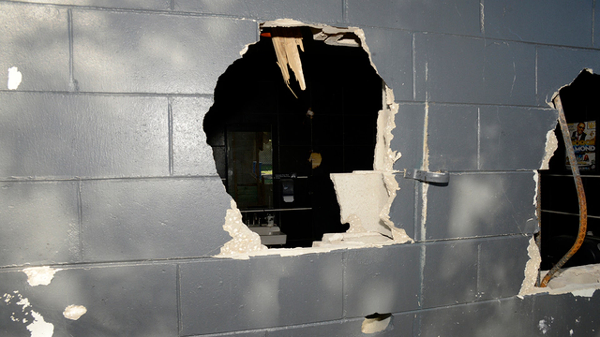 Police blasted a hole through an outside wall to provide an exit for many people trapped inside. 