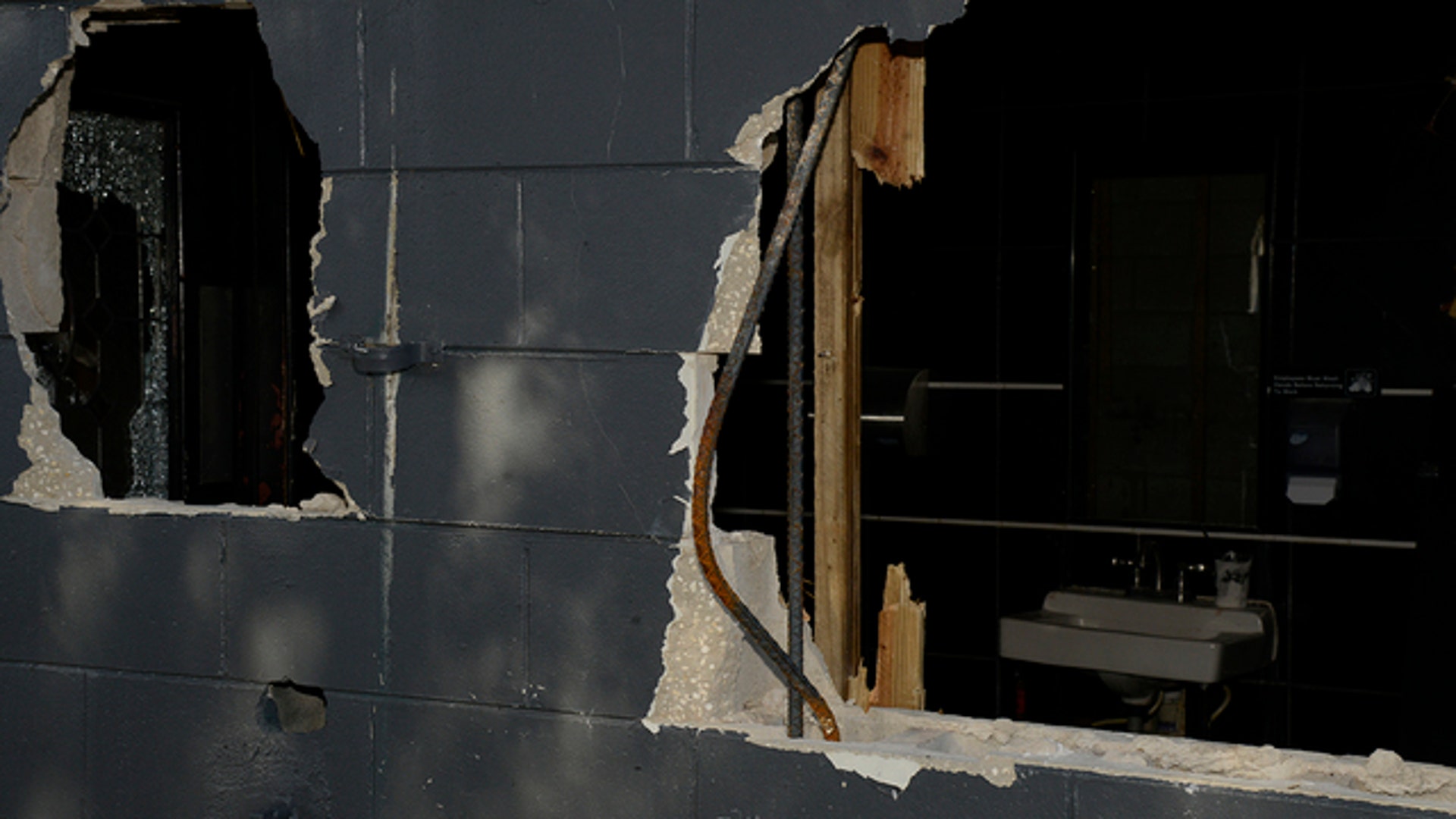 Police blasted a hole through an outside wall to provide an exit for many people trapped inside. 