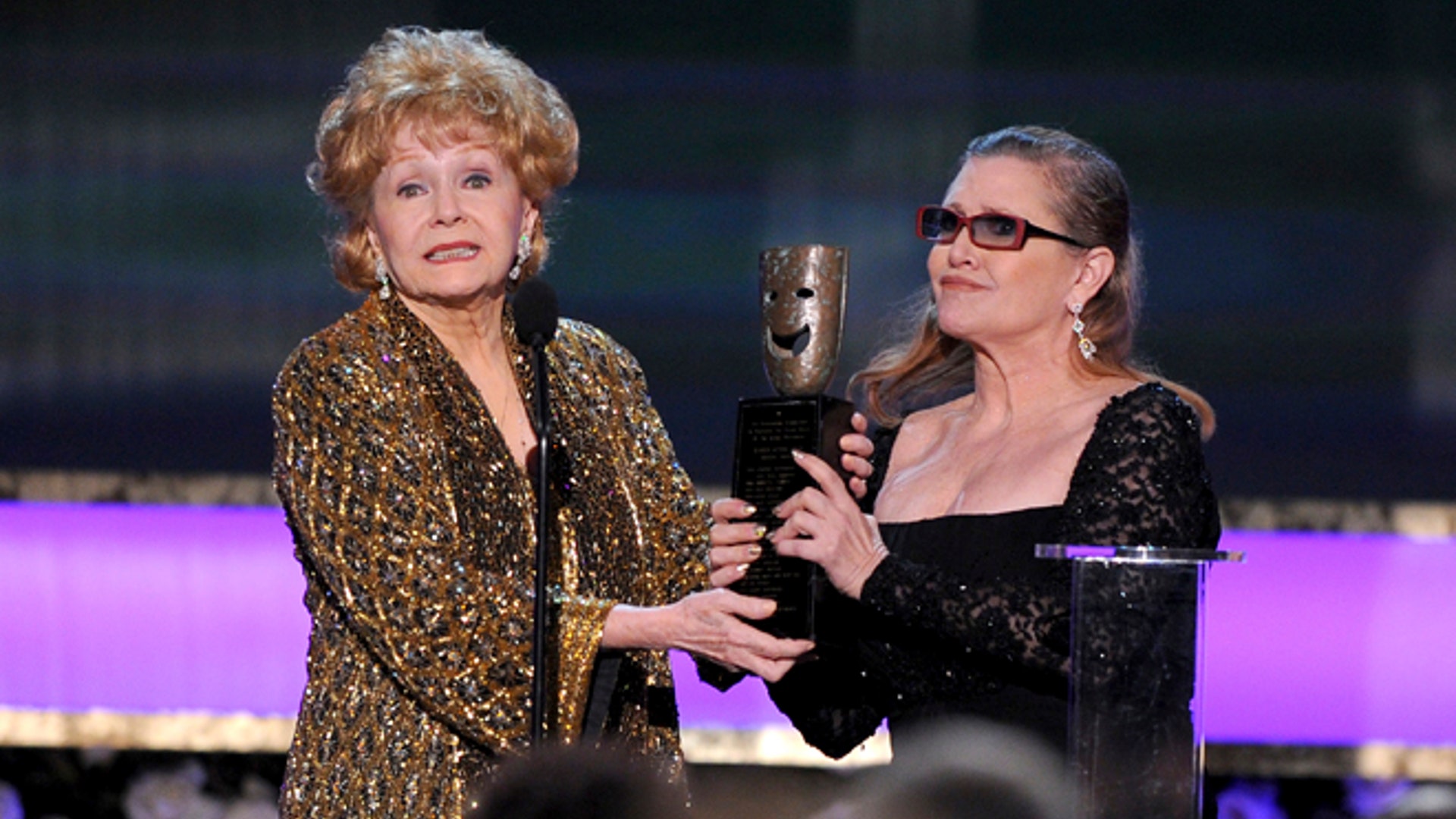  Jan. 25, 2015: Carrie Fisher, right, presents her mother Debbie Reynolds with the Screen Actors Guild life achievement award at the 21st annual Screen Actors Guild Awards at the Shrine Auditorium in Los Angeles.