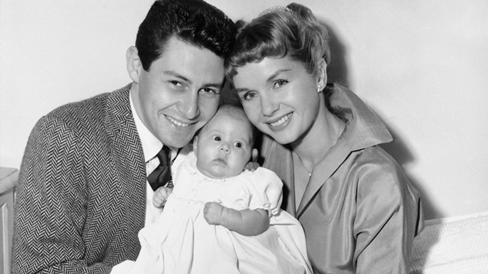 Jan. 2, 1957: Eddie Fisher and Debbie Reynolds hold their baby daughter, Carrie Frances Fisher, as the pose for a photo in the Hollywood area of Los Angeles. 