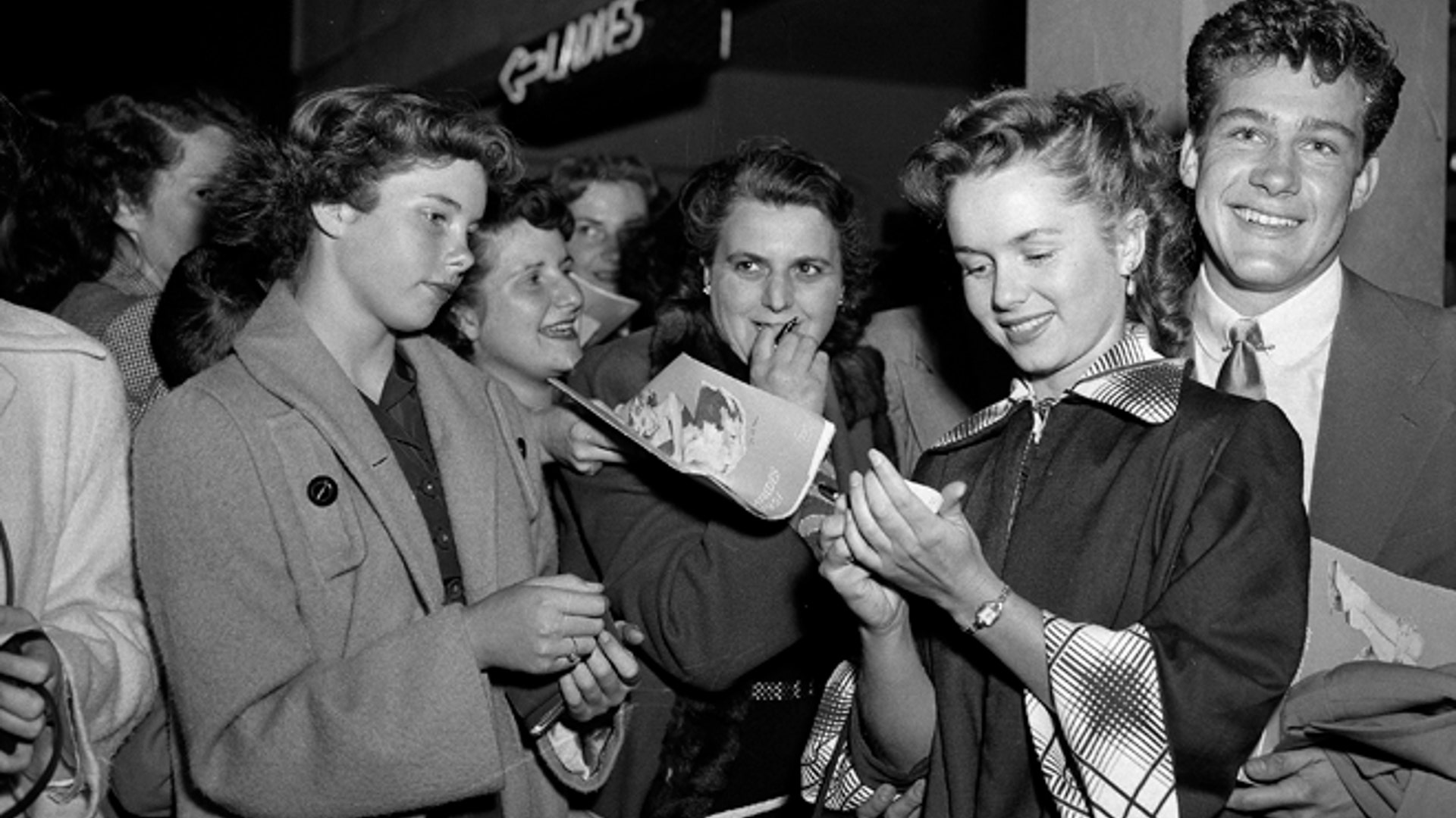 May 7, 1951: Actress Debbie Reynolds signs autographs on her way into the ice show in the Hollywood section of Los Angeles. 