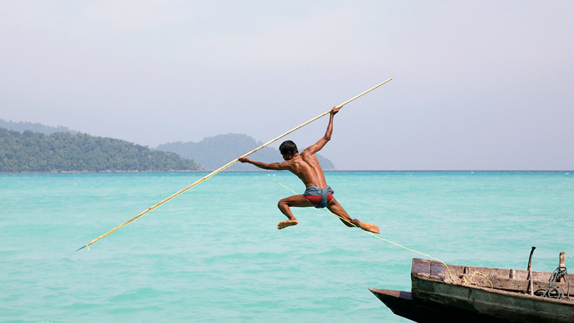 A sea gypsy spear fishing on the Andaman Sea.