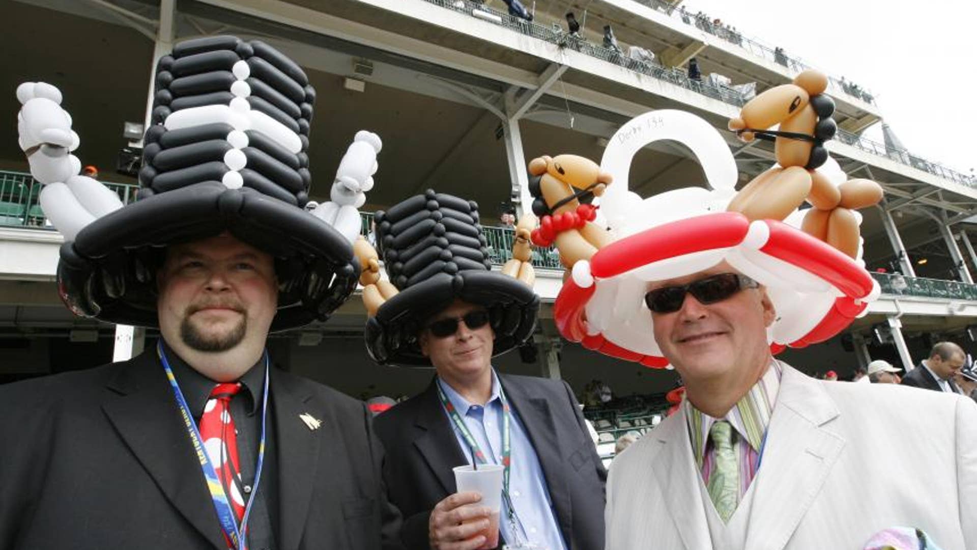 Three men with balloon hats