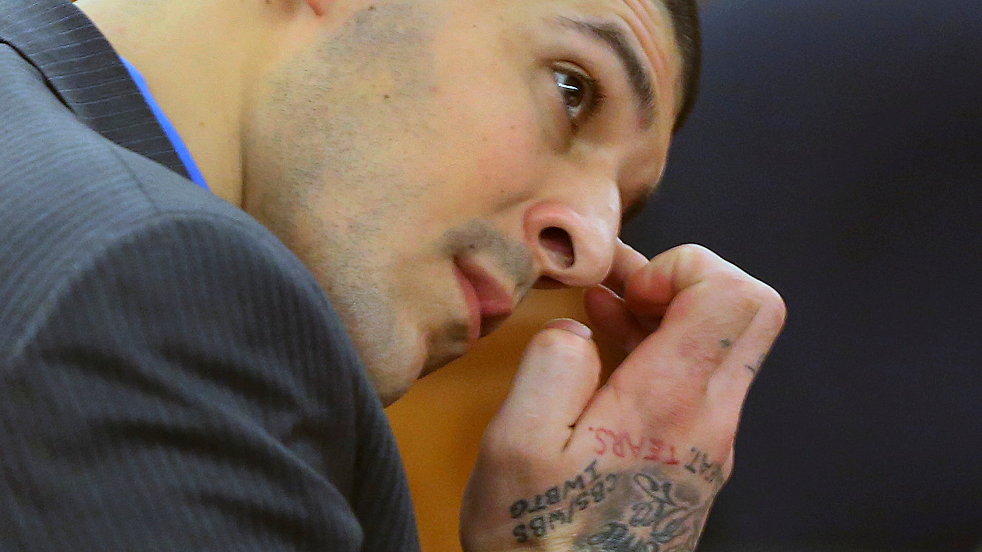 Hernandez wipes his face as he listens to the judge speak to the jury during closing arguments of his murder trial.