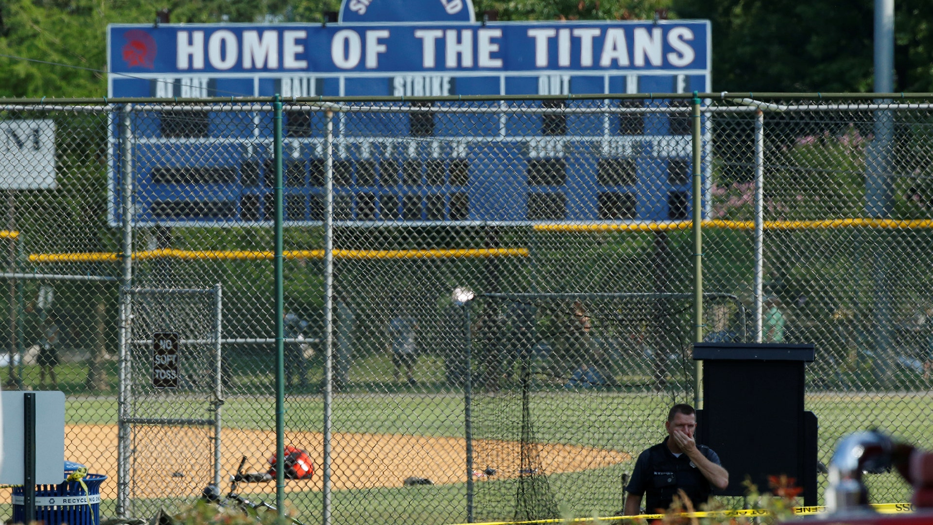 Police investigate a shooting scene after a gunman opened fire on Republican members of Congress during a baseball practice