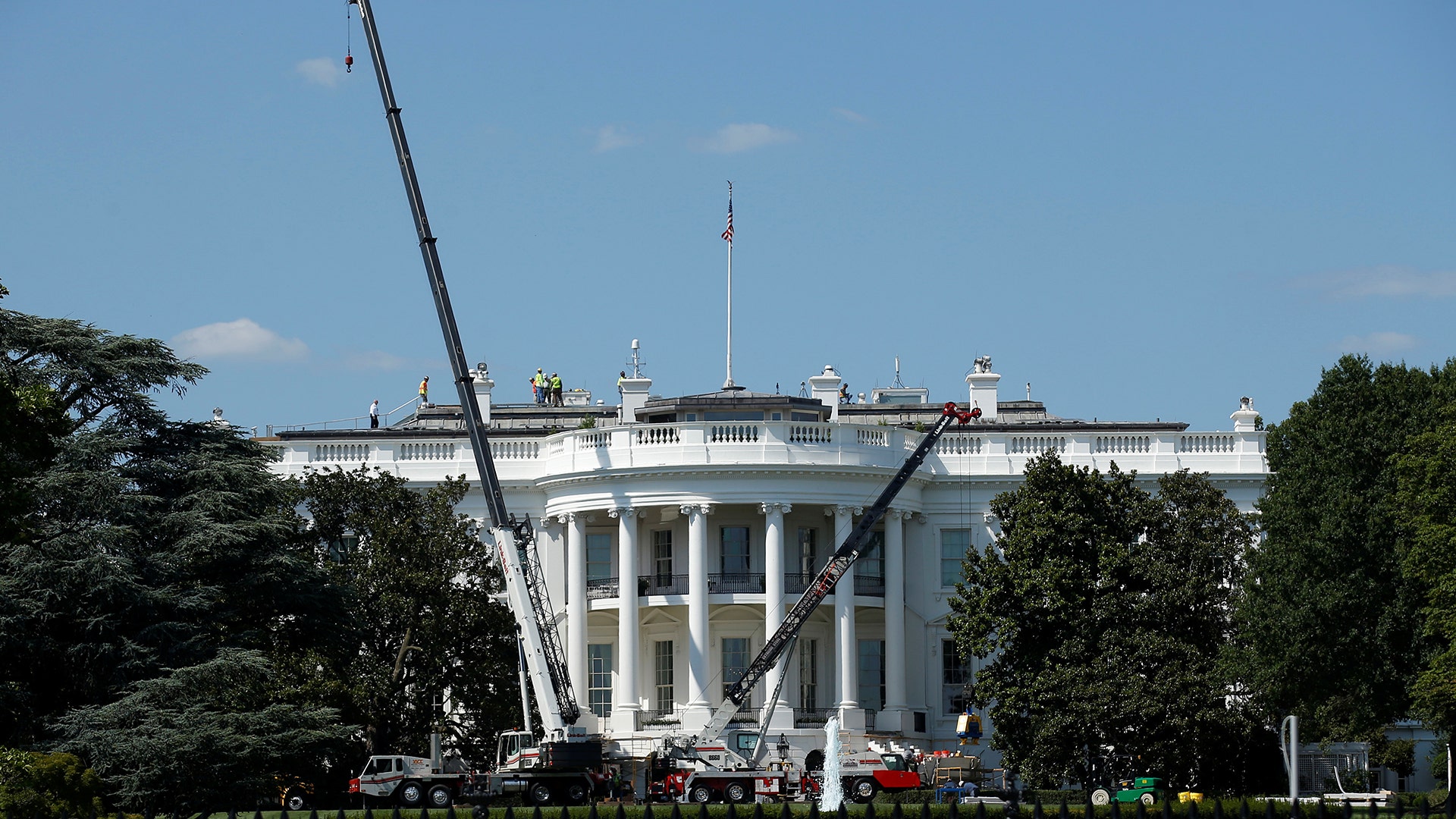 Construction cranes are set up while U.S. President Donald Trump is away on vacation from the White House in Washington
