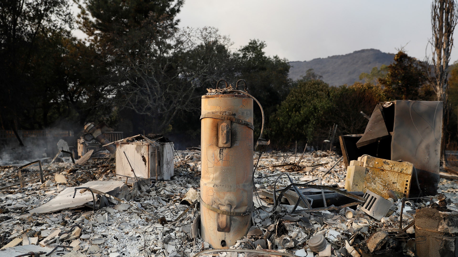A water heater stands on top of remains of a home destroyed by the Nuns Fire along Napa Road in Sonoma, California October 9, 2017