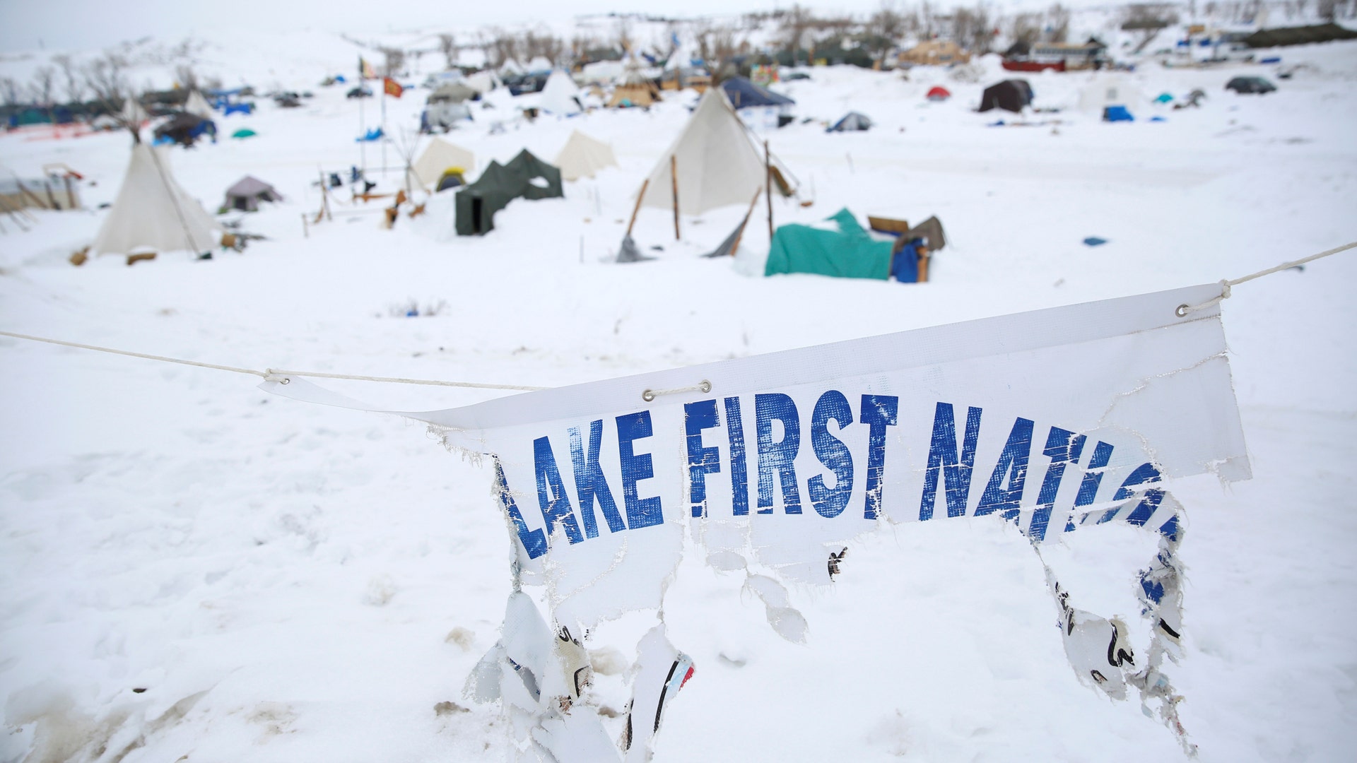 A weathered tribal flag flies over the Dakota Access Pipeline protest camp.