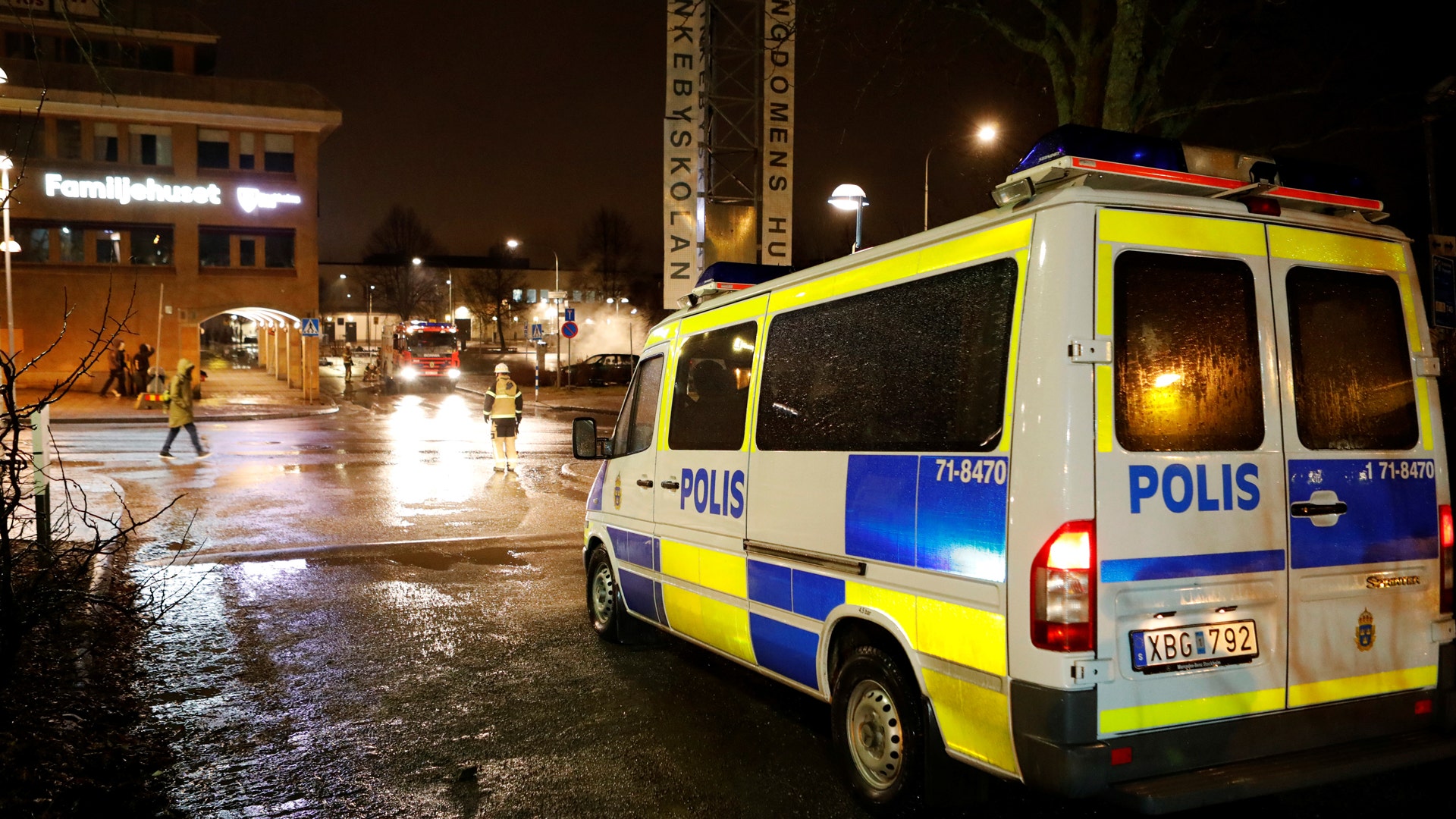 A police car is seen as several cars were set on fire during a riot in Rinkeby, outside Stockholm, Sweden.