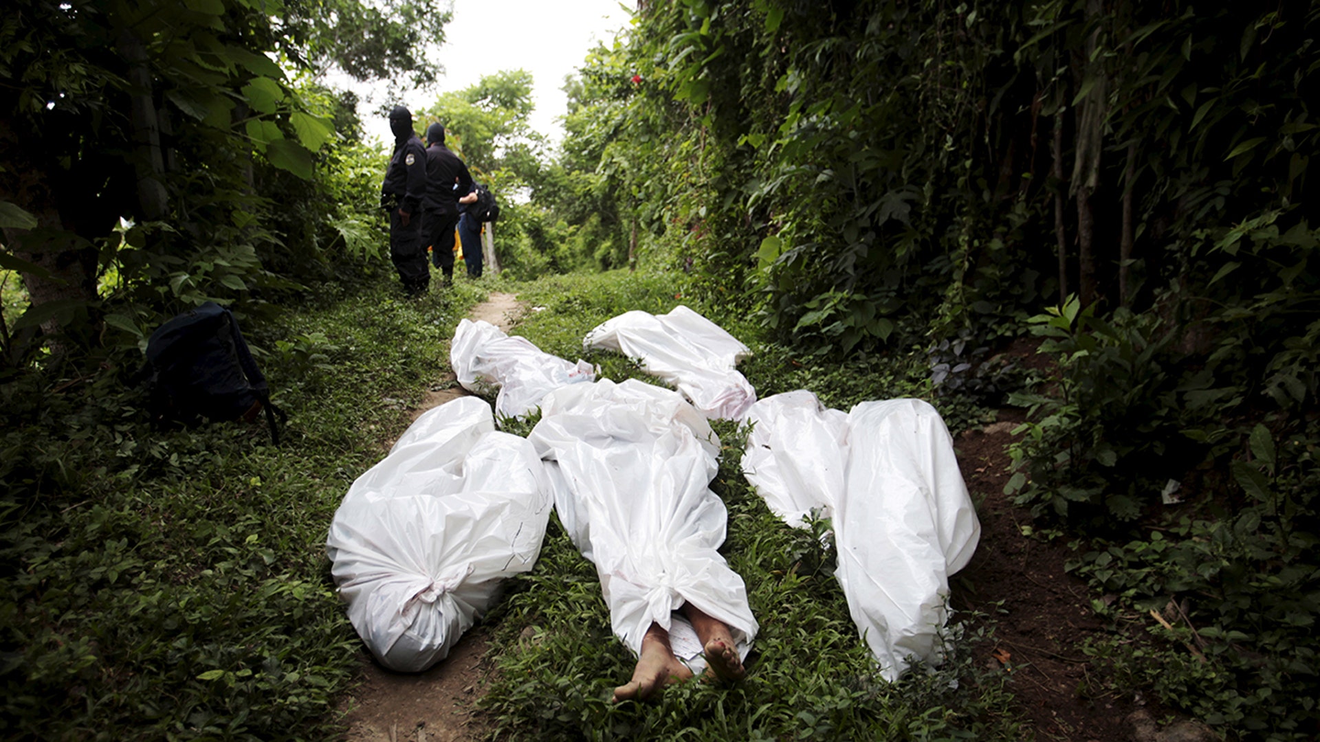 The bodies of members of the Barrio 18 gang are seen on the town of San Pedro Perulapan 