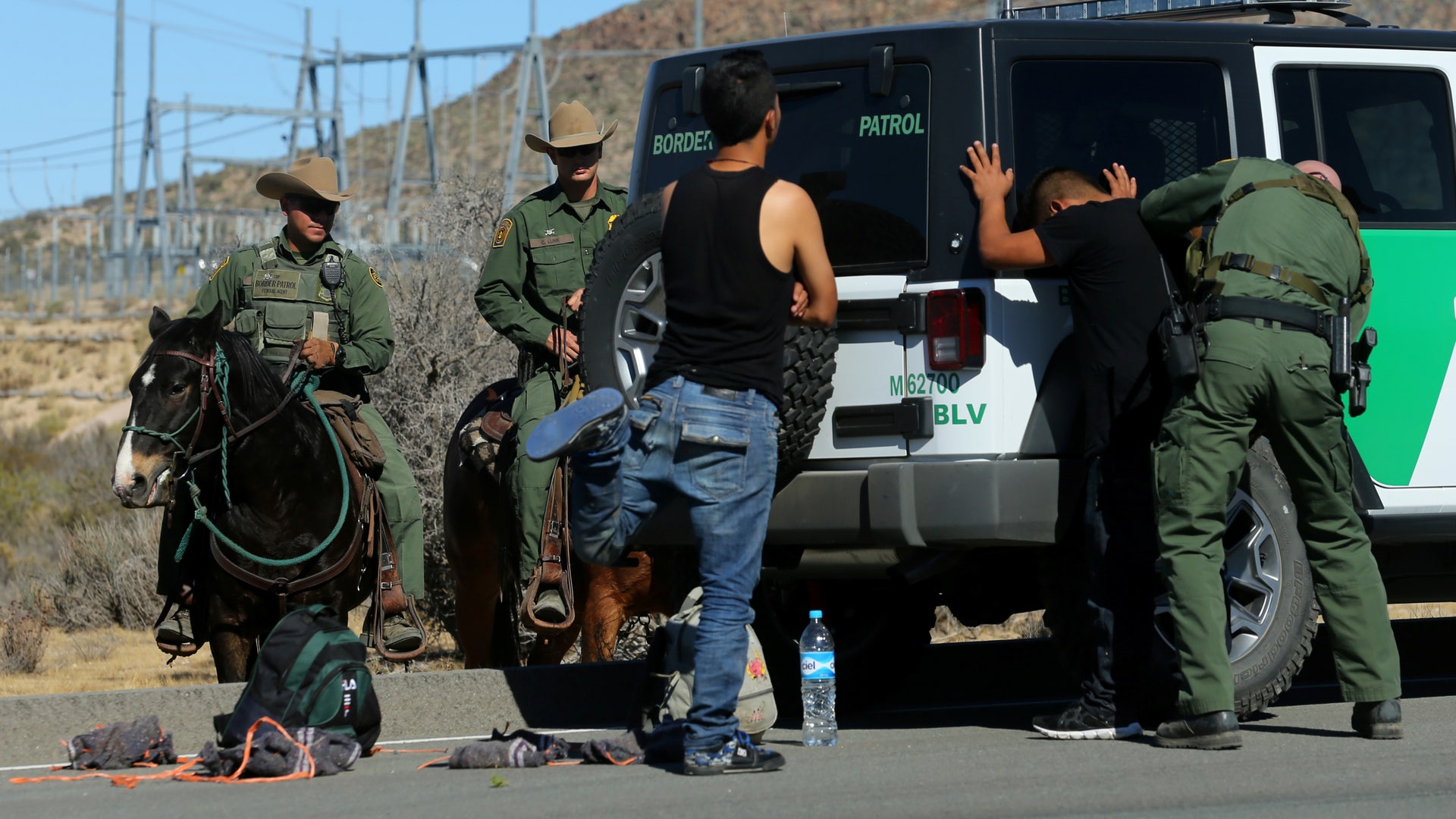 U.S. Border Patrol supervisor Bobby Stine frisks a man a few hundred meters from the U.S.-Mexico border fence near Jacumba, California.