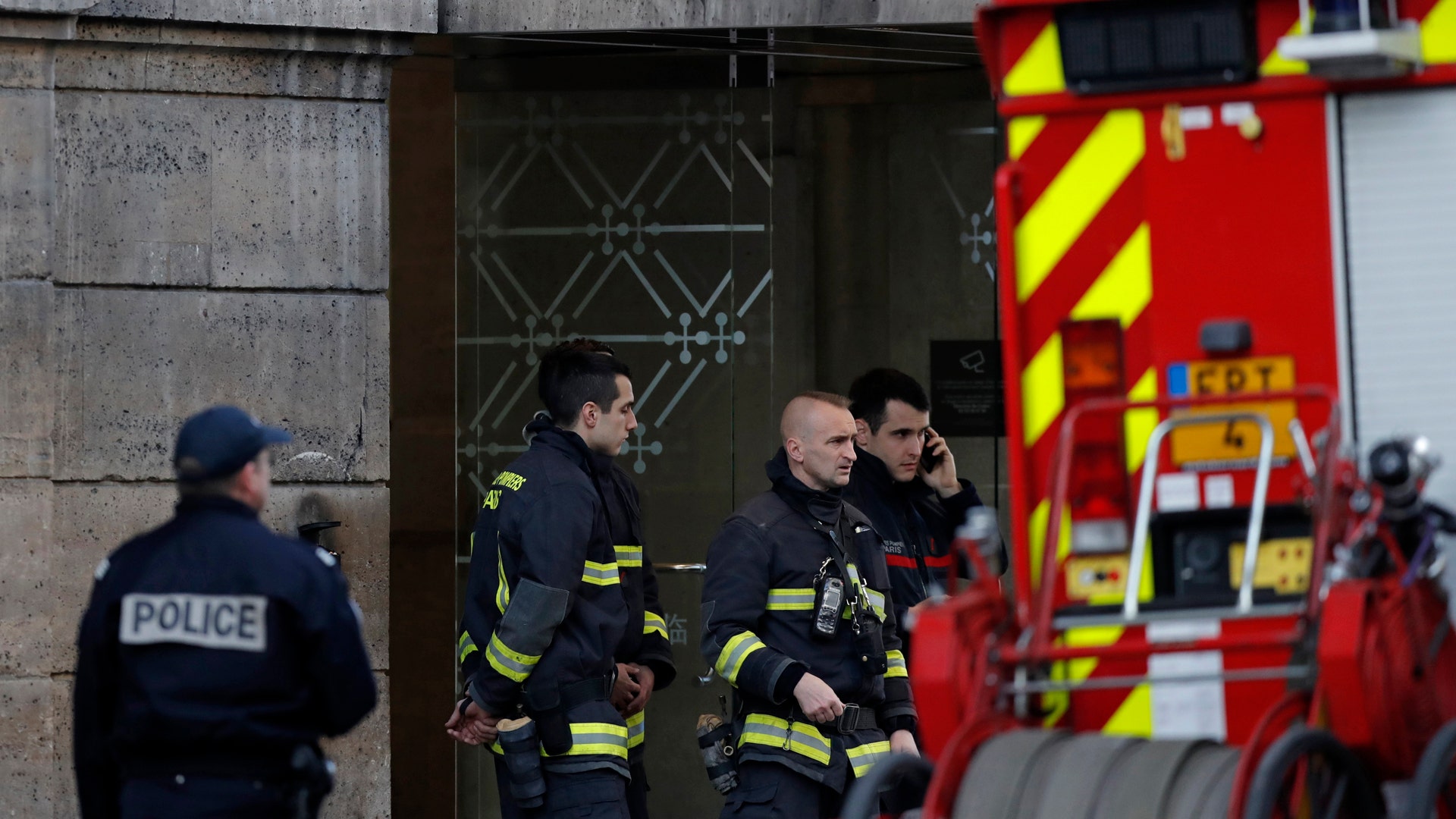 French police and firefighters are seen in front of the street entrance of the Carrousel du Louvre in Paris, France, February 3, 2017.