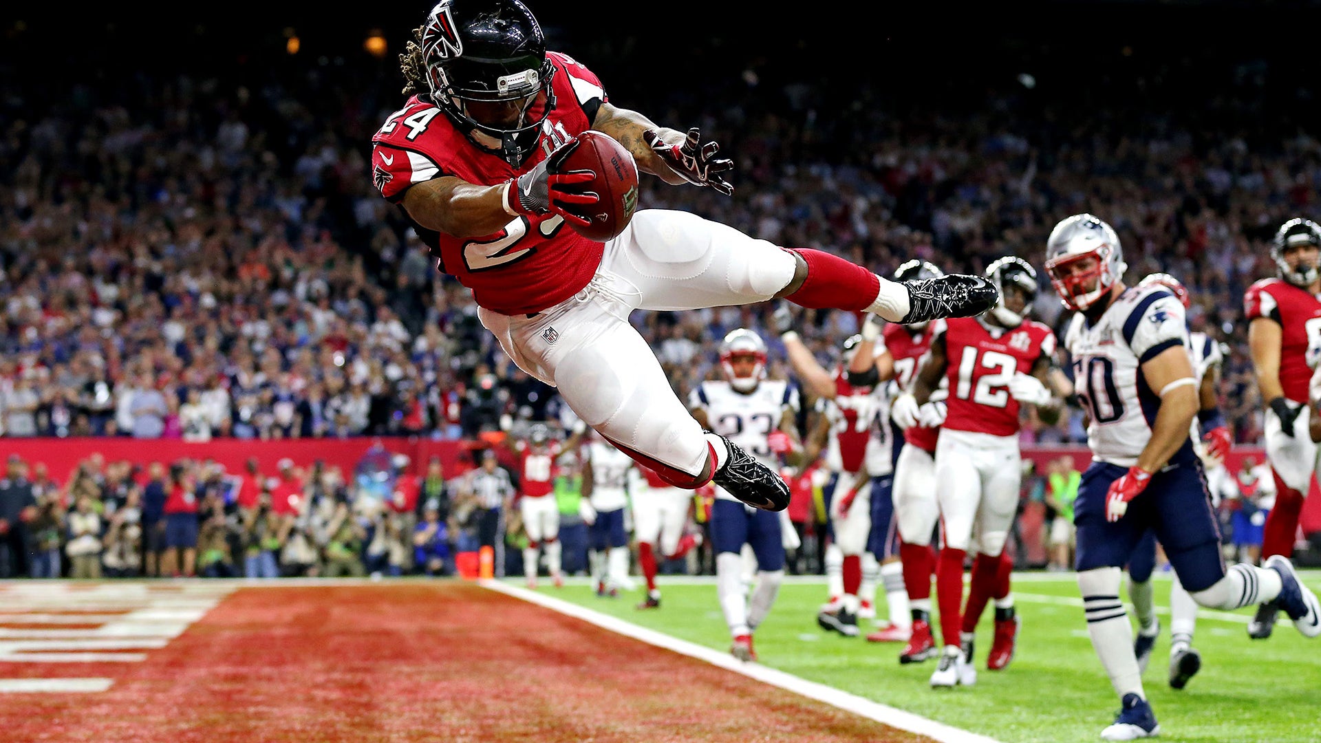 Feb 5, 2017; Houston, TX, USA; Atlanta Falcons running back Devonta Freeman (24) scores a touchdown during the second quarter against the New England Patriots during Super Bowl LI at NRG Stadium.