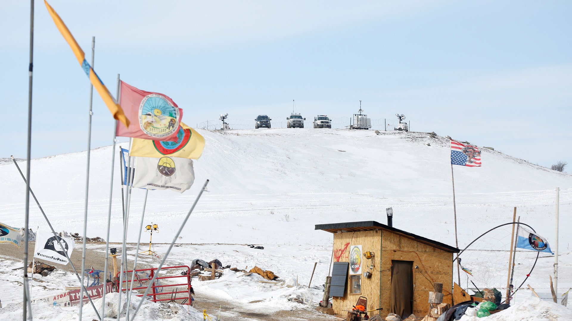 Police vehicles idle on the outskirts of the opposition camp against the Dakota Access oil pipeline.