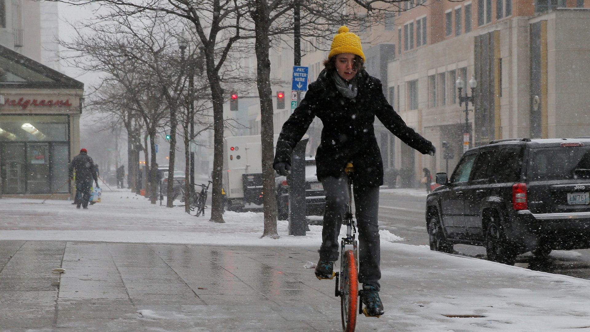 Rebecca Bailey rides a unicycle during a winter nor'easter snow storm in Boston, Massachusetts.