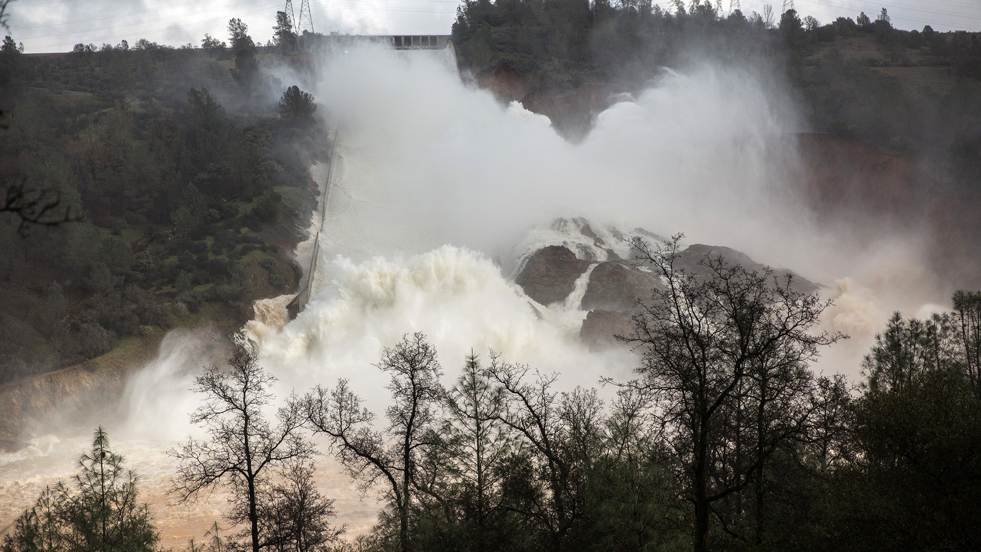 Water flows through a damaged spillway on the Oroville Dam in Oroville, California.